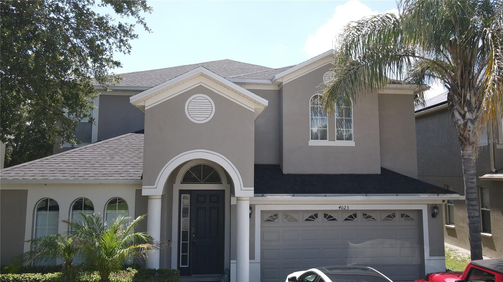 Proudly presenting this beautifully maintained, 3,375+ sq ft executive residence in Pasco County's highly favored Country Walk neighborhood. This impressive two-story design accommodates 6 bedrooms and 3 full baths, highlighted by an expansive formal living and dining area crafted for grand entertainment. The heart of the home features a spectacular kitchen, meticulously detailed with crown molding, stainless steel appliances, and a breakfast area. In the adjacent family room, a modern electric fireplace creates a striking focal point, complemented by premium ceiling fans throughout the home. At the touch of a button, remote-controlled blinds glide open along the triple sliding glass doors to reveal your private outdoor oasis. Step out into the large screened-in lanai to relax, unwind, and enjoy a peaceful, unobstructed rear pond view. Retreat to the upper level to discover a massive secondary bonus room alongside the remaining spacious bedrooms. Positioned safely in a low-risk Zone X flood area, this tech-enhanced property perfectly combines luxury, modern convenience, and resort-style community amenities just minutes from Wesley Chapel's finest dining and shopping hubs.