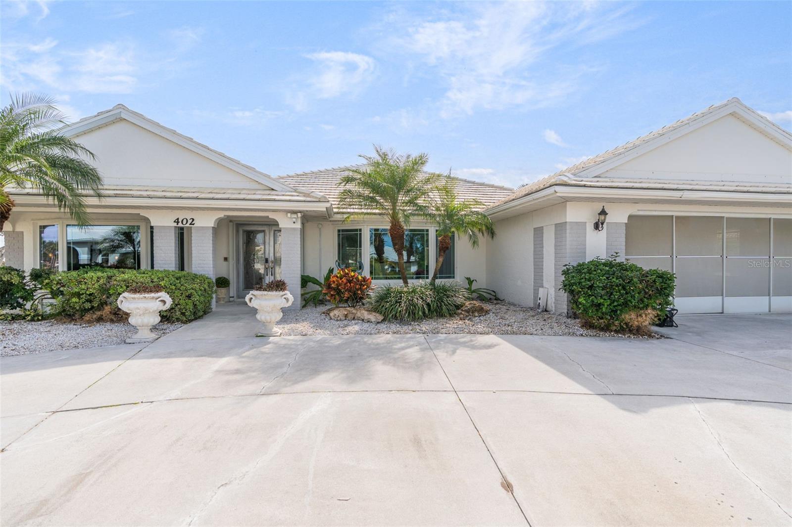 Exceptional Home in an Exceptional Neighborhood! Set on a prized corner lot with tranquil water views, this 2747 sq. ft TURNKEY residence offers the perfect blend of elegance, space and location. Polished Travertine floors throughout flow seamlessly throughout the home, creating a timeless cohesive look while enhancing the light filled interiors. Originally a model home, it features thoughtfully designed living spaces: an airy, light filled, sunken living room; a kitchen that boasts granite countertops, a walk in pantry, an island, and a pass through to the lanai; a spacious family room that shows off an inviting stone fireplace, tinted pocket doors, and a full bath that leads out to the pool. The elegant primary ensuite is complete with walk in closets and water views. Enjoy your private oasis in the large sparkling heated pool that overlooks a tranquil lakefront view.  The pool was resurfaced in 2016 and a new pool cage was added in 2025. In addition, a new HVAC system was added in 2025. Located in the highly desirable Plantation Golf & Country Club, this home places you just minutes from beaches, the Atlanta Braves Spring Training Stadium, Downtown Wellen Park, shops and restaurants. Whether enjoying peaceful mornings overlooking the water or entertaining guests in a refined coastal setting, this property delivers the lifestyle that you deserve, in one of the area's most coveted locations. CASH ONLY. Call for an appointment today!