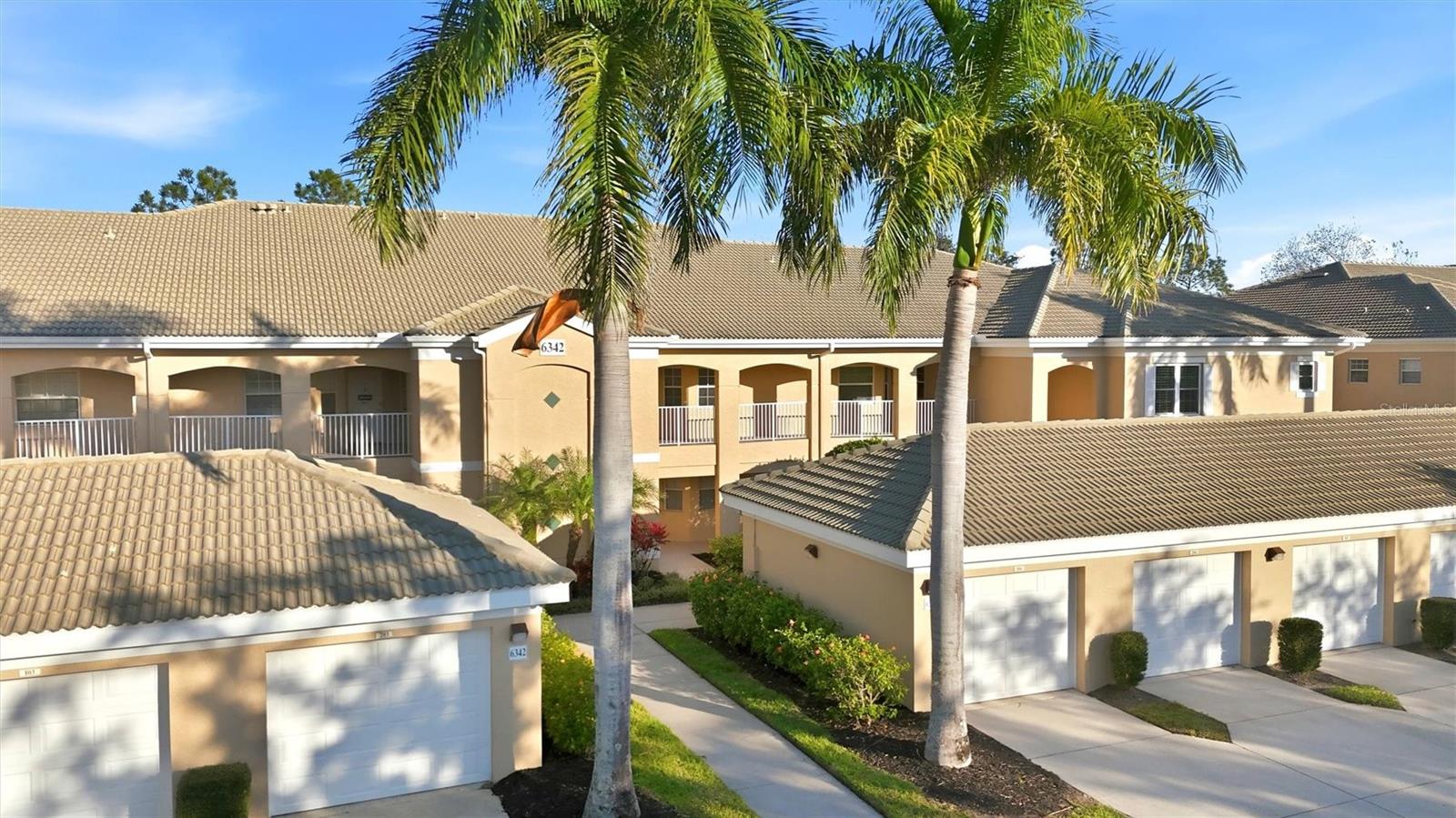 Price Adjustment! Golf-course views and easy condo living come together in Grand Oak at Tara Condominiums. This updated, second-floor 2-bedroom + den (currently has Murphy bed), 2-bath home offers 1,346 sq ft with a comfortable, practical layout. The extended kitchen includes updated granite counters, a full appliance package, and a pantry. A built-in counter in the Morning Room adds extra versatility—use it as a desk, prep space, or casual bar. The enclosed, east facing lanai is a standout, with screens and Eze Breeze coverings that create a Florida-room feel—morning sun, cooler afternoons, and a relaxing view of a pond and the 18th hole of the golf course. Golf membership is optional. An inside laundry closet keeps daily routines simple, with washer and dryer included. The primary suite features a full bath and two closets, and you’ll appreciate Storm Saver windows in the primary bedroom along with storm shutters for the front of the condo. An outdoor closet near the front door and a one-car garage provide surprising amounts of storage. Furnishings including Murphy Bed are negotiable. Condo fees include exterior maintenance, water, sewer, cable, and internet. Community amenities include walking trail,  tennis courts, and pools. Shopping is nearby and the popular UTC Shopping and Entertainment District is a 10 minute drive, as is the growing
Marketplace at Heritage Harbour. Top rated beaches including Anna Maria Island and Siesta Key are approximately  a 30 minute drive. Schedule your showing and see how easy condo living can feel.