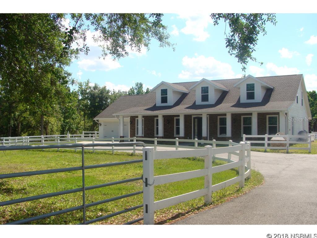 SPRUCE CREEK FARMS CUSTOM ESTATE HOME LOCATED ON A PRIVATE STREET WITH OVER 3 ACRES! Five stall barn, ranch style fencing, private small pond, oversized driveway and plenty of room for all your recreational vehicles! No HOA, bring your boat and RV! The floor plan features 5 bedrooms with 4 baths, a huge bonus room up with a wet bar! The 2 additional bedrooms up do not have closets. The master bedroom and bath are located on the main floor with an additional two bedrooms and two baths. The second bonus up can be counted as a 6th bedroom! There is also an office off the kitchen with a built-in desk and Murphy bed. The Dream gourmet kitchen has all top of the line SS appliances, a wine refrigerator, granite counter tops and custom wood cabinets! The five stall barn is equipped with feed and tack room and huge upper loft! Oversized 2 car garage and there is also an air conditioned workout room (13 x 10) off of the garage with its own outside entry. Conveniently located to major roadways, Daytona Beach and New Smyrna Beach! This property may be under audio/visual surveillance.