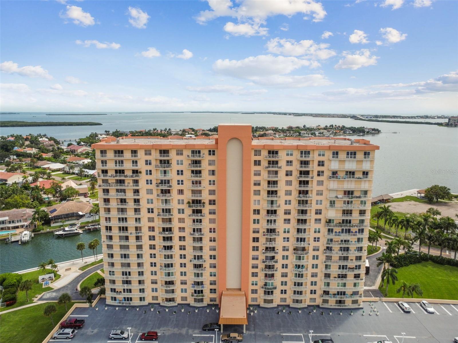 2023 Award-winning community. MAGNIFICENT AND EXPANSIVE WATER VIEWS OF BOCA CIEGA BAY from this pristine BAYWAY ISLES POINT BRITTANY BUILDING SIX. Corner Unit.  The open floor plan enhances a seamless flow from the condo’s split bedroom concept to a private 30-foot covered balcony with impressive views from every room.  The primary bedroom presents gorgeous views of the bay, a sizable walk-in closet, The guest bedroom provides another beautiful view of the bay and a vast walk-in closet. Bayway Isles Point Brittany Six is one of the area's 55+ waterfront communities offering resort-style amenities. Gated entry with elegant clubhouse and exquisite tropical foliage. For those who enjoy an active lifestyle Bayway Isles Point Brittany Six offers a fitness center, library, card room, four heated pools, a spa, lighted clay tennis courts, fishing docks, a private boat dock, and a kayak launch and storage, and a peaceful walking trail meandering through the manicured flower beds and along the waterfront. On-site electric charging stations. Stellar location and only 6 minutes to vibrant downtown St Petersburg, gulf beaches, golfing at Isla Del Sol Yacht & Country Club, Eckerd College, as well as local markets, shopping, restaurants, and healthcare. Easy access to I-275, Tampa International Airport, and St Pete Beach voted Best Beach in the USA 2021. Near Fort Desoto Park with miles of secluded beach to wander. Island living at its best! Once you see this unit you will not forget it! WOW!