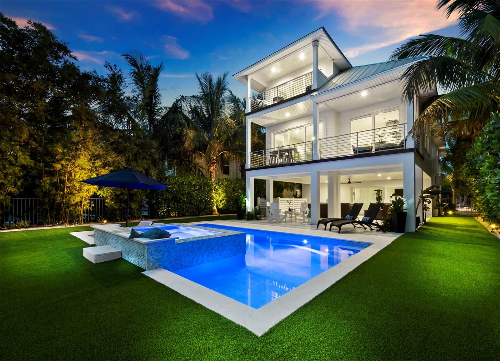 Welcome to this luxurious oasis nestled in the idyllic neighborhood of Longbeach Village on the north end of Longboat Key. This stunning property offers a serene and sophisticated coastal living experience while the location offers the best of island living, making this property truly exceptional. The main floor boasts a flowing open-concept floor plan designed to maximize comfort and functionality. Large sliders grace the living area, inviting abundant natural light and providing seamless access to a generous deck, perfect for entertaining. The kitchen is a culinary enthusiast's dream with a large center island, pristine white-maple shaker cabinetry, and Cambria Torquay surfaces. Enjoy the convenience of natural gas cooking and top-of-the-line Wolf and Sub-Zero appliances. The owner's suite comprises the entire upper floor and is a haven for relaxation.  The ensuite is spa-like with elegant fixtures and finishes. There are dual walk-in closets with built-in shelving, ensuring ample storage space for your wardrobe. The owner's suite also boasts a spacious deck overlooking the pool and preserve, creating a private retreat for morning coffee or sunset cocktails. There are two additional bedrooms both offering their own en-suite and one has a private balcony. A spacious downstairs bonus space gives way through sliders to an expansive covered patio. The outdoor oasis includes a saltwater heated pool with a sundeck and a spa, creating an ideal setting for relaxation and recreation. The lushly landscaped backyard is fully fenced and overlooks a protected green space, ensuring ultimate privacy. Water access is just a stone's throw away, allowing you to explore the Gulf of Mexico beaches known for their white sands and turquoise waters. Sarasota Bay is also within reach, offering quick access to Longboat Pass. The community has a public dock and boat ramp for those who love boating, kayaking, paddle boarding, and fishing. This exquisite residence offers the perfect blend of elegance, comfort, and outdoor enjoyment, while providing the peace of mind that comes from high quality weather resistant construction materials designed for modern coastal living. Whether you're looking for a peaceful retreat or an entertainer's dream, this property has it all. Don't miss the opportunity to call this slice of paradise your home.