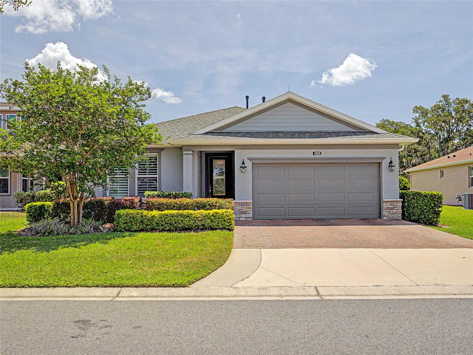 Welcome to this exceptional Shea Homes Connect Model located on a premium homesite in the highly sought-after gated community of Ocala Preserve. Built in 2020, this meticulously maintained 3-bedroom, 2.5-bathroom home with a dedicated den/flex room offers a rare combination of builder upgrades and owner enhancements, creating a truly custom living experience. Situated on a premium homesite, the property enjoys peaceful views of mature oak trees, natural green space, and a scenic walking path, creating a private setting with beautiful sunrise views. From the moment you arrive, the attention to detail is evident. The home features a decorative brick front elevation, professionally enhanced landscaping, an expanded paver driveway, full gutter system, epoxy-coated garage floor, water softener system, and smart home features. Inside, you'll find tile flooring throughout, crown molding, upgraded 6.5-inch baseboards, plantation shutters, recessed lighting, and a premium lighting package. The open-concept design is ideal for both everyday living and entertaining, while the dedicated den offers the perfect space for a home office, hobby room, or additional living area. The chef-inspired kitchen showcases 42-inch cabinetry, additional custom cabinetry for expanded storage, stone countertops, a premium hexagonal tile backsplash, and an abundance of workspace and storage. Every detail was carefully selected to elevate both style and functionality. The primary suite serves as a private retreat featuring an updated shower floor, upgraded glass shower enclosure, tiled shower walls, and custom closet organization. Additional custom closet systems throughout the home maximize storage and organization, while the laundry room has been enhanced with additional cabinetry and a utility sink. Outdoor living is where this home truly shines. A substantial rear paver patio expansion creates an incredible outdoor gathering space, complete with a custom summer kitchen. Perfect for entertaining or relaxing, the outdoor living area extends your enjoyment of Florida's year-round lifestyle. Significant investments in upgrades and post-construction improvements make this one of the most customized Connect Models in Ocala Preserve, featuring a premium homesite, expanded outdoor living space, upgraded finishes, plantation shutters, custom closet systems, and numerous enhancements throughout. Located just minutes from the World Equestrian Center, shopping, dining, and medical facilities, Ocala Preserve offers an unmatched resort-style lifestyle. Residents enjoy access to golf, pickleball, tennis, fitness centers, walking and biking trails, kayaking, fishing, spa services, social activities, dog parks, and a vibrant clubhouse. HOA fees include landscaping maintenance, allowing for truly low-maintenance living. This is a rare opportunity to own a highly upgraded home on a premium homesite within one of Ocala's most desirable resort-style communities.