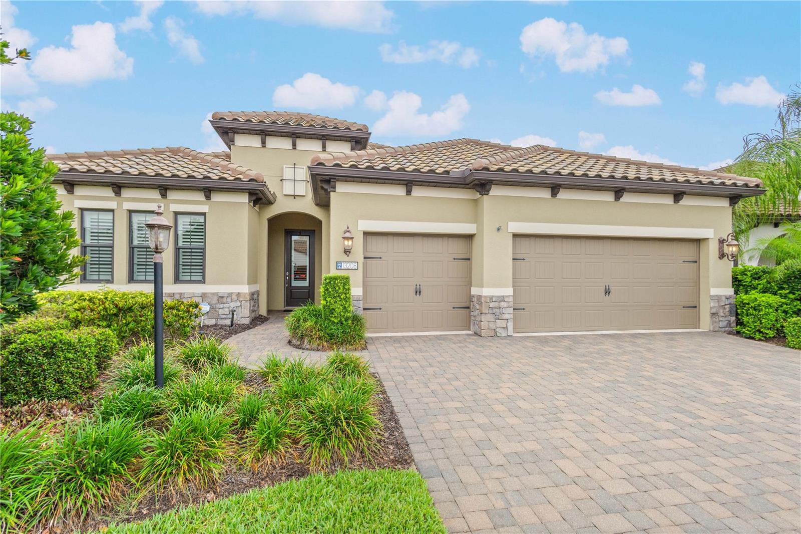 Welcome to Indigo, where clean modern design and comfortable Florida living come together in this beautifully appointed pool home. Built in 2018, this 4-bedroom, 3-bath residence offers almost 2,700 square feet of thoughtfully designed living space filled with upscale finishes, architectural detail, and indoor-outdoor living. As you step through the front door, you’re immediately welcomed by tall ceilings, modern tile flooring, and elegant architectural accents that give the home a warm yet elevated feel. Plantation shutters throughout provide a timeless touch, while decorative wood ceiling details and custom wall millwork add texture and character to the main living spaces. The open-concept living area was designed for both everyday comfort and easy entertaining, seamlessly flowing into the heart of the home where you’ll notice a stunning kitchen featuring a large center island, beautiful pendant lighting, a gas cooktop, and a full-height backsplash that extends to the ceiling for a dramatic designer touch. The spacious layout allows the kitchen, dining, and living spaces to all connect effortlessly while still feeling refined and intentional. The large pocket sliders open up the living space completely to the outdoor lanai, creating that true Florida indoor-outdoor living. Outside, the pool area is surrounded by beautiful paver decking and enhanced by remote controlled privacy shades, creating the perfect setting to relax, enjoy quiet evenings at home, or entertain with ease. The saltwater pool features a sun shelf and six hot jets, creating a peaceful resort-style atmosphere in your own backyard. Additional peace of mind comes with a pool pump replacement completed in May 2026. Privately tucked away, the primary suite offers a private retreat with a spacious layout and spa-inspired feel, while the split-bedroom design provides comfort and privacy for family and guests alike. Additional upgrades include impact windows throughout the home and an enhanced AC system featuring a UV light for improved air quality and efficiency. Located within the gated community of Indigo in Lakewood Ranch, residents enjoy access to resort-style amenities including a clubhouse, fitness center, community pool, pickleball courts, bocce ball, and an active lifestyle just minutes from shopping, dining, and top-rated schools.