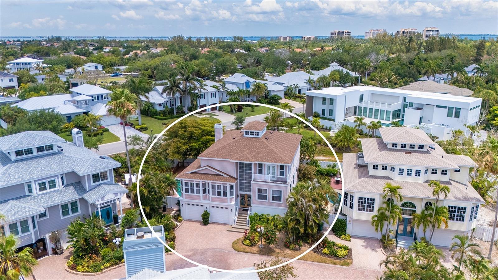 Welcome to island living on Longboat Key, one of Sarasota's premier barrier island destinations. In Triton Cove, this coastal residence offers direct Gulf Beach access across the street and a lifestyle designed for boating, seasonal use or year-round living along Florida's Gulf Coast. Enjoy nightly sunsets along Gulf of Mexico Drive or experience world-class dining and shopping on nearby St. Armands Circle. An elevated entry leads to the main living level, where expansive glass defines the open-concept design, connecting the living room, kitchen and dining areas. Positioned within a five-residence enclave, this property offers convenient access to Sarasota dining, shopping and waterfront recreation while supporting a low-maintenance ownership experience. This tri-level single-family home features four bedrooms and 2.5 baths, complemented by a two-car garage with dual 8-foot doors and extensive storage. The ground level includes multiple flexible-use rooms ideal for fitness, storage or organization of beach equipment, kayaks, bicycles and boating gear. A dumbwaiter provides direct access from the garage to the kitchen. Interior features include engineered wood flooring in main living areas and new carpet in bedrooms. The kitchen is designed with wood cabinetry, granite countertops, deep storage drawers, an appliance garage, a rollout pantry wall and stainless steel appliances, including a GE wall oven/microwave combo, an induction cooktop and an LG refrigerator. Additional features include a wet bar with cabinetry and a mirrored wall, an electric fireplace and plantation shutters. The primary suite offers a private setting with dual vanities, a soaking tub, a separate shower, two walk-in closets and a Juliette balcony with partial gulf views. The third level includes a bonus room suitable for media, an office or a private retreat. Outdoor living includes a natural gas-heated pool and spa, an outdoor shower and a private fenced setting. Pool systems including a new motor, filters and heater, and the interior of the pool has been refinished. Recent improvements include a 2024 shingle roof with warranty, zoned HVAC systems installed in 2018 and 2020, and a 2025 water heater. The home includes a monitored alarm system. Triton Cove offers a maintained environment with low monthly HOA fees of $500, including landscape maintenance of common areas, pest control, pool service and exterior lighting. Leasing is permitted up to four times annually with a one-month minimum. Located near Longboat Key Bayfront Park and Longboat Dog Park, residents may enjoy pickleball, tennis, playgrounds and picnic areas. Nearby conveniences include grocery, pharmacy, boat rentals and storage options along Longboat Key, as well as being within reach of Sarasota amenities. Optional membership to the Longboat Key Club provides access to golf, tennis, beach and social amenities, enhancing the gulf-front lifestyle experience on Florida's west coast. Don’t miss out on your private tour of this special coastal home featuring four bedrooms, 3000-plus square feet of air-conditioned living space, a two-car garage, a 30-foot pool and a hot tub on Longboat Key with beach access with low taxes for under $2 million; this is an extraordinary value!