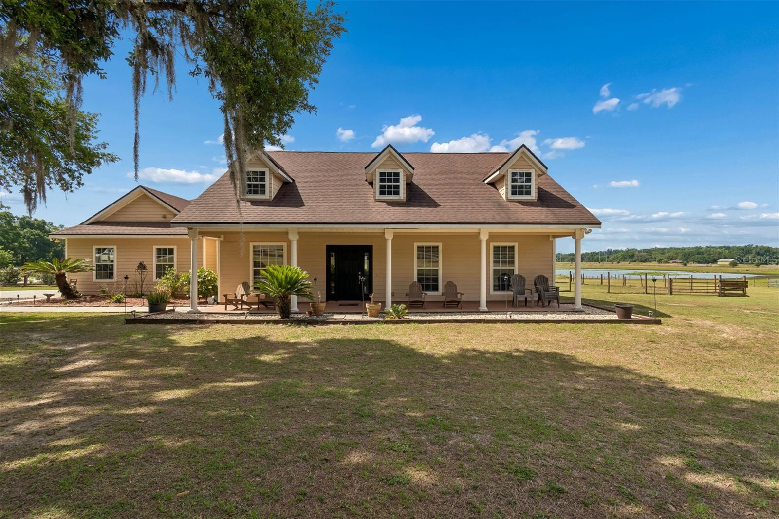 Welcome to your private country retreat! Situated on 6 picturesque acres, this beautifully maintained 3-bedroom, 2.5-bath home with a dedicated office offers the perfect blend of comfort, space, and peaceful rural living. Step inside to an inviting open floor plan featuring spacious living areas, elegant finishes, and a stunning stone fireplace that creates a warm and welcoming centerpiece. The office provides an ideal space for working from home or can easily serve as a flex room or guest space.

Enjoy serene views from nearly every room and entertain with ease in the screened pool area complete with a relaxing spa and expansive covered lanai. Whether you're sipping coffee on the charming front porch, hosting gatherings by the pool, or enjoying the open acreage and scenic surroundings, this property is designed for both relaxation and lifestyle.

With plenty of room for animals, recreational vehicles, gardening, or future additions, this exceptional property offers endless possibilities while still providing the comfort and functionality of a thoughtfully designed home. A rare opportunity to own a peaceful slice of paradise with modern conveniences and timeless charm.