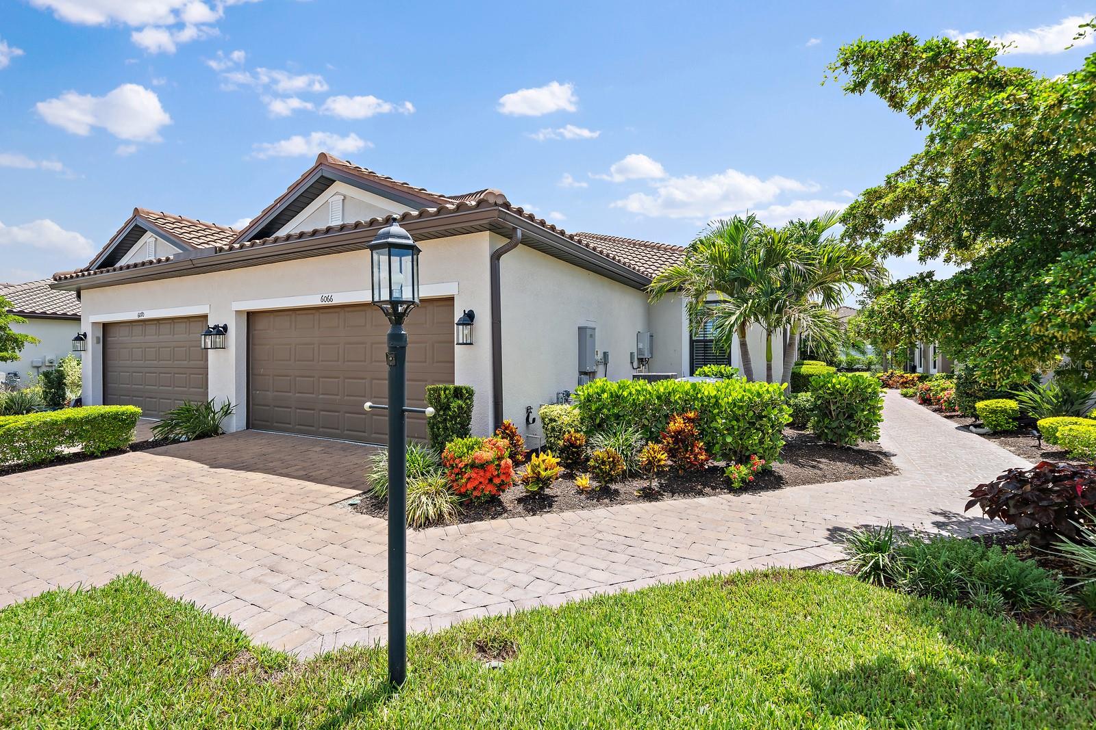Welcome to 6066 Mesa Glen, Bradenton, FL an impeccably maintained, move-in-ready home that blends luxury finishes with thoughtful upgrades in a desirable maintenance-friendly community. From the moment you arrive, you'll appreciate the beautifully landscaped exterior, paver driveway, tile roof, and inviting screened lanai overlooking a peaceful backyard.

Inside, the open-concept floor plan is filled with natural light and features elegant tile flooring throughout the main living areas, laminate flooring in both bedrooms, tray ceilings, and a spacious great room that flows seamlessly into the gourmet kitchen and dining area. The kitchen offers quartz countertops, stainless steel appliances, abundant cabinetry, a large center island with seating, and stylish pendant lighting.

The primary suite is a private retreat featuring custom California Closets, while the primary bath includes dual vanities, a large walk-in shower, and an additional California Closets cabinet above the toilet for exceptional storage. The dedicated office is enhanced with a beautiful custom California Closets built-in bookshelf, making it perfect for working from home.