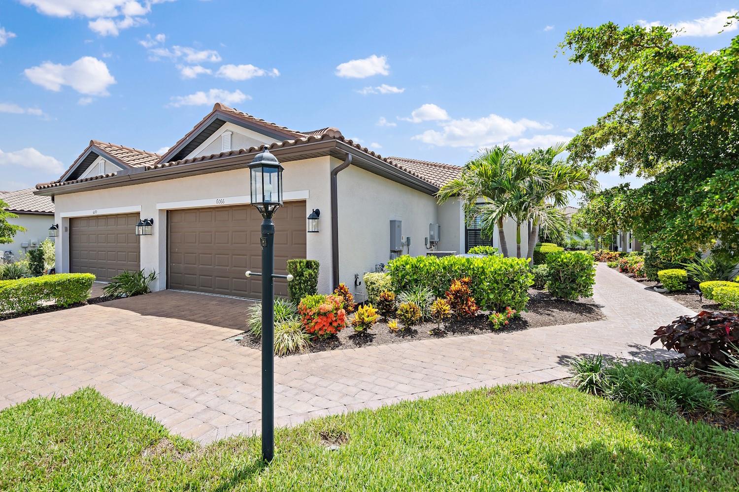 Welcome to 6066 Mesa Glen, Bradenton, FL an impeccably maintained, move-in-ready home that blends luxury finishes with thoughtful upgrades in a desirable maintenance-friendly community. From the moment you arrive, you'll appreciate the beautifully landscaped exterior, paver driveway, tile roof, and inviting screened lanai overlooking a peaceful backyard.

Inside, the open-concept floor plan is filled with natural light and features elegant tile flooring throughout the main living areas, laminate flooring in both bedrooms, tray ceilings, and a spacious great room that flows seamlessly into the gourmet kitchen and dining area. The kitchen offers quartz countertops, stainless steel appliances, abundant cabinetry, a large center island with seating, and stylish pendant lighting.

The primary suite is a private retreat featuring custom California Closets, while the primary bath includes dual vanities, a large walk-in shower, and an additional California Closets cabinet above the toilet for exceptional storage. The dedicated office is enhanced with a beautiful custom California Closets built-in bookshelf, making it perfect for working from home.