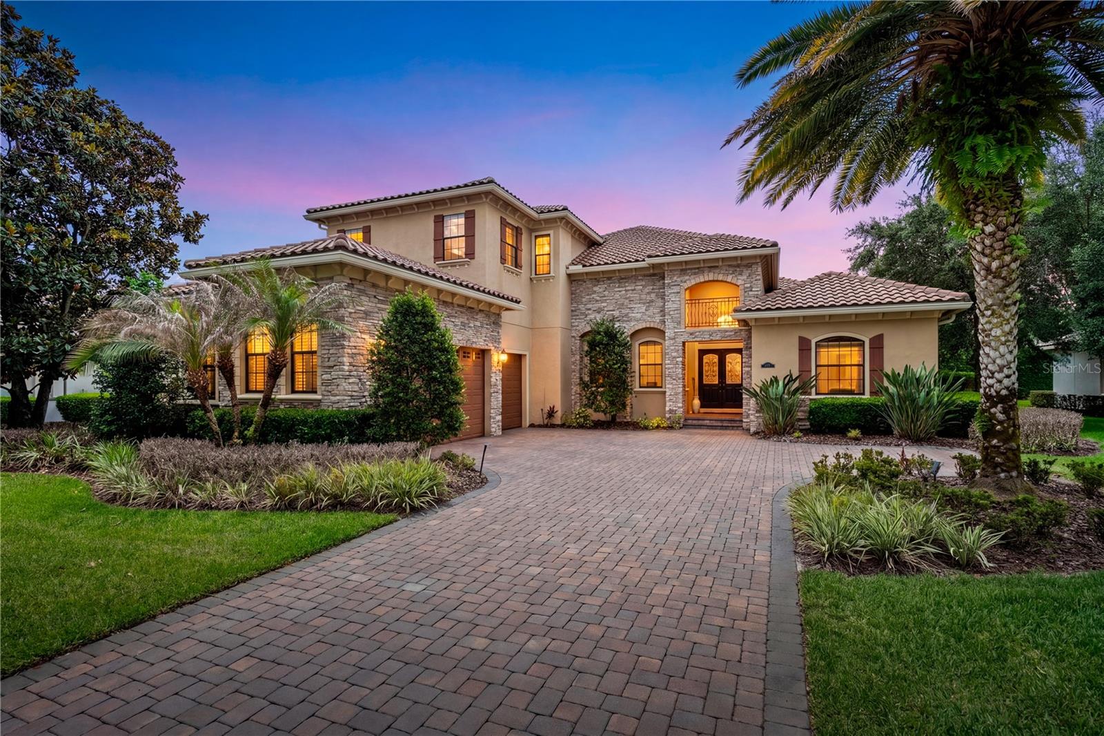 Tucked away in “The Gardens” of the desirable guard gated golf course and lakefront community of Keene’s Pointe, this beautifully maintained 4-bedroom, 4.5-bath residence offers 4,037 square feet of thoughtfully designed living space on nearly a half-acre pond front homesite. Lovingly used only as a vacation home by its current original owners, the property presents in exceptional, like-new condition—showcasing pristine finishes, high-end appliances, and 12 to 14 ft ceiling heights throughout this estate home.
This versatile floor plan features the primary retreat on the main floor along with two oversized secondary bedrooms that share a deluxe full bathroom and a spacious 4th Bedroom with a full bath located just steps from the pool.   The floor plan’s flexibility is further enhanced by a second floor bonus room that would make a fabulous 5th Bedroom or office to include a sitting area, large full bathroom and walk in closet.    
Enter through elegant double doors into an inviting great room that seamlessly connects to a well-appointed kitchen and breakfast nook with pool views and an open concept living area - perfect for both everyday living and entertaining. Step outside to a covered paver patio overlooking a private backyard oasis featuring a deluxe summer kitchen with natural gas grill and wet bar as well as a saltwater pool, heated spa, and fully fenced yard.  Enjoy tranquil pond views complete with a lighted fountain, stunning sunset vistas, and even Disney fireworks in the distance. Additional highlights include a three-car garage and paver driveway, enhancing both curb appeal and functionality.
Built in 2012, this is one of the newer homes in Keene’s Pointe offering modern construction, double pane windows, timeless design, and an unbeatable setting.