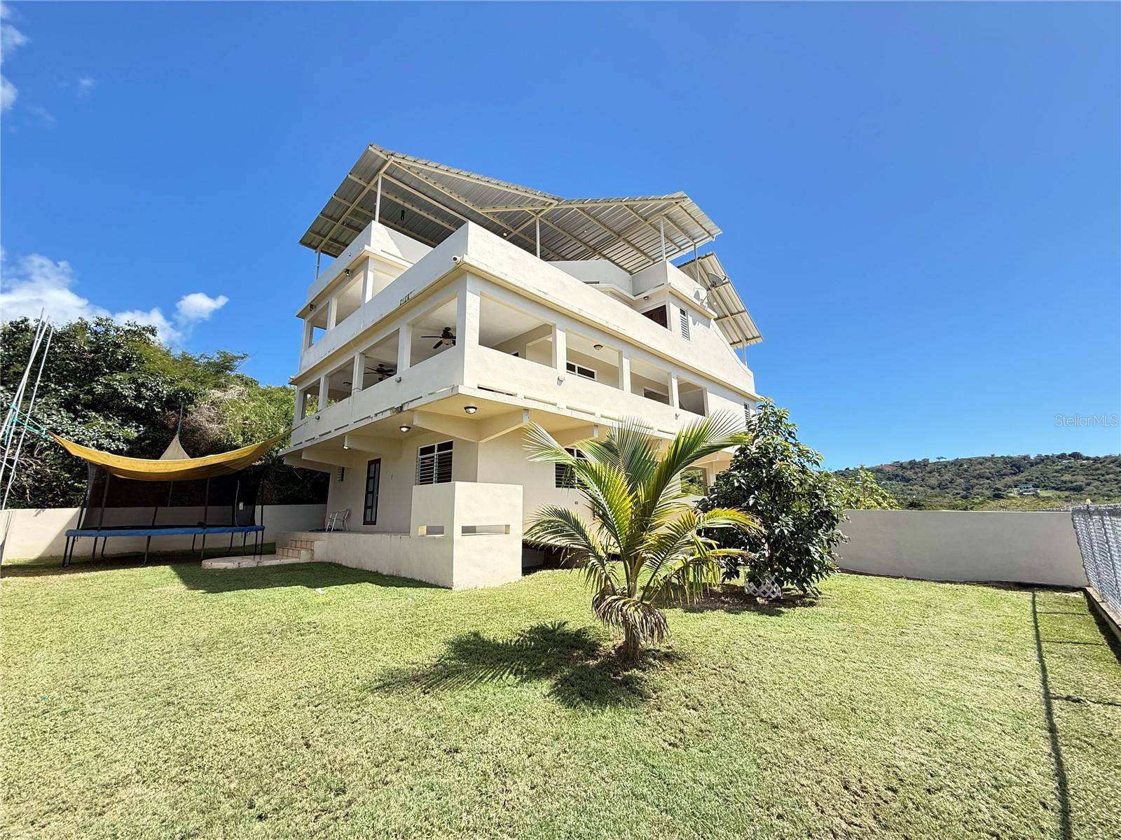 This unique property features two separate homes on a 9,115 sqmt lot, offering space, privacy, and endless possibilities. The main house is a stunning three-story residence with a rooftop terrace and breathtaking ocean views, designed for open, airy living. The second home provides additional living space, perfect for guests, rental income, or extended family. Whether you’re looking for a private retreat or a smart investment, this estate offers the best of both worlds.
 
Main House – A Three-Story Home with Spectacular Views
With a total of 3,094 sq. ft. of GLA, this three-level home is designed to embrace natural light and panoramic scenery while providing space, comfort, and functionality.

First Level – Seamless Indoor-Outdoor Living
* Inviting living area with direct access to the patio
* Flexible kitchen space for added convenience
* Two bedrooms connected by a Jack and Jill bathroom

Second Level – Spacious & Open Design
* Living area with abundant natural light
* Direct access to the kitchen
* Large bedroom with a private terrace offering breathtaking ocean views 
* Second terrace with a private jacuzzi
Third Level – A Private Retreat
* Expansive master bedroom with stunning ocean views
* Generous en-suite bathroom
* Private terrace featuring an outdoor kitchenette, ideal for intimate gatherings