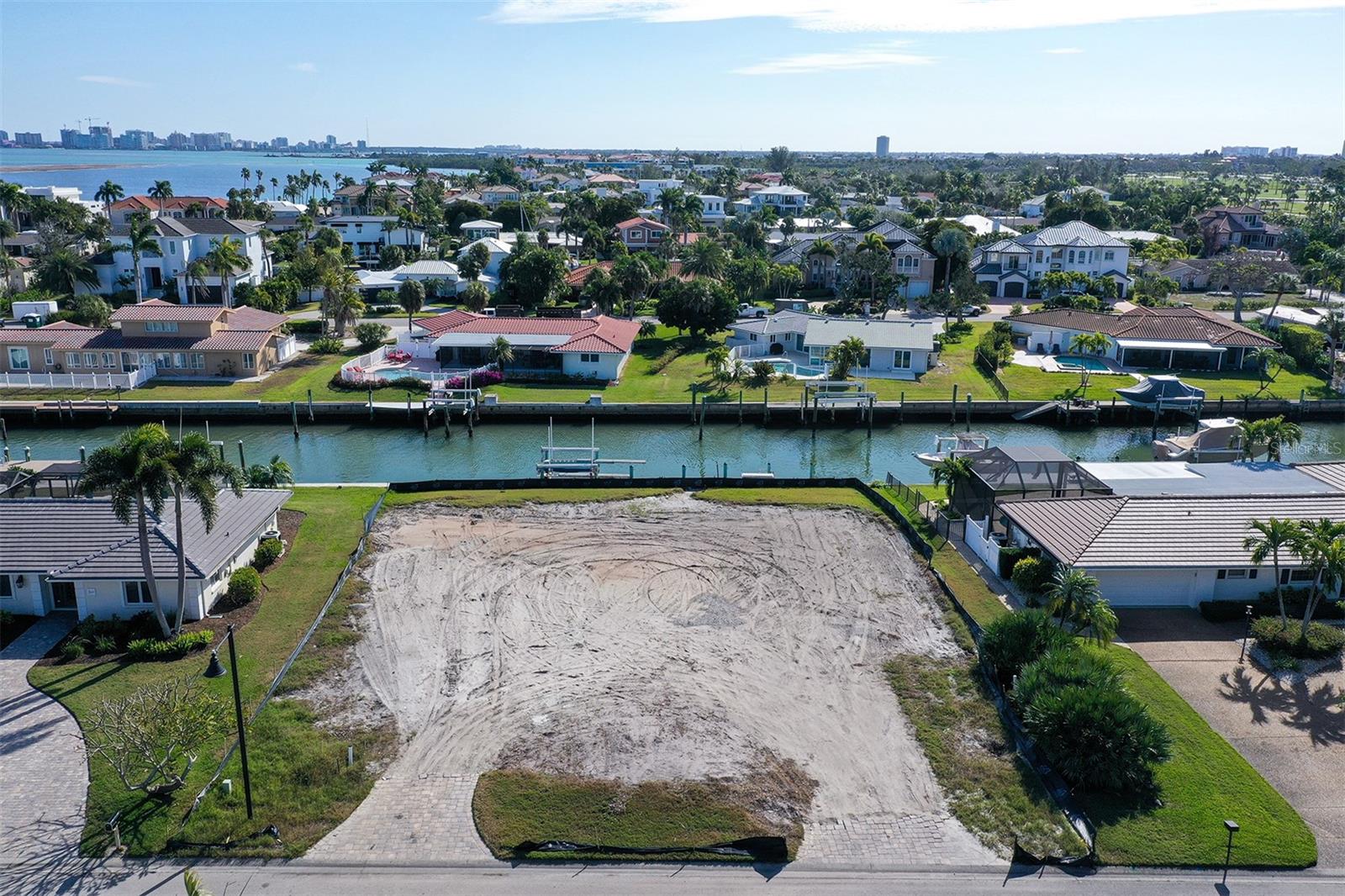 536 Gunwale Lane, with its south facing waterfront location, is ideally situated for the best of island living. Recently cleared, this highly sought waterfront lot in Country Club Shores offers the perfect opportunity to design and build the legacy home you’ve been dreaming of…enjoy fantastic boating on protected deep water with direct access to the Bay, Intracoastal, and Gulf waters and a private deeded beach access just moments away. Sitting between two world class resorts, the Longboat Key Club for golf, tennis and dining and the newly completed St. Regis Resort Hotel offering its menu of luxuries. And of course, the exceptional shopping and dining on St Armands Circle and the many cultural venues of downtown Sarasota are there to enjoy. This exceptional property is over 12,400 sq. ft. with 106 feet of canal frontage. There is a dock and lift in place. Natural gas is available and there is access to a shared well for irrigation. Bring your builder and your vision to design a home for your lifestyle on the beautiful island of Longboat Key. Buyer to verify all building requirements
