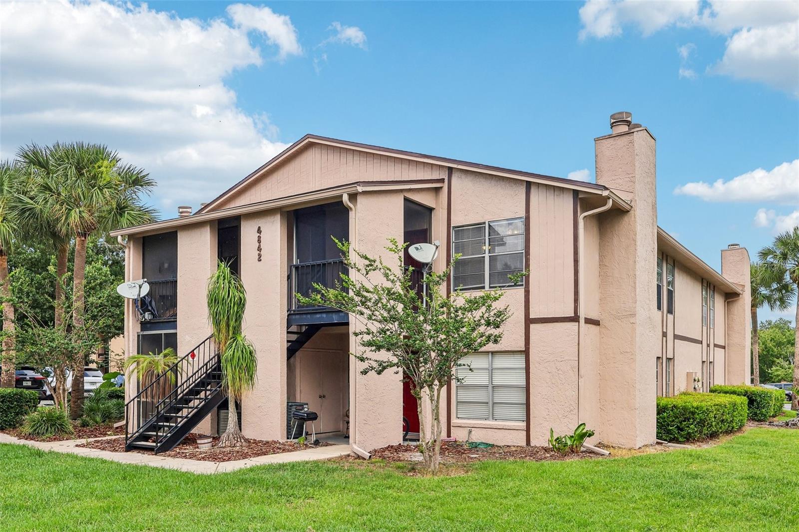 One or more photo(s) has been virtually staged. NEW ROOF (2024) ~ UPDATED A/C (2023), NEWER WATER HEATER (2023), and EXTERIOR PAINT (2021), make this second-floor condo an easy choice for anyone seeking LOW MAINTENANCE LIVING in a convenient Orlando location! Situated in the well-maintained Southbrook community, this home offers SOARING CEILINGS, no neighbors above, and peaceful views of a large GREEN SPACE from the SCREENED PORCH. Inside, TILE FLOORING runs throughout for effortless upkeep, while the OPEN LIVING & DINING AREAS feel bright and spacious thanks to the vaulted ceiling and abundant natural light. A cozy FIREPLACE creates a welcoming focal point in the living room, and the dedicated dining space makes it easy to gather with family or entertain friends. The UPDATED KITCHEN features upgraded cabinetry for ample storage and a breakfast bar that connects seamlessly to the dining area, creating a functional layout. The PRIMARY SUITE is positioned at the rear of the home and features a large WALK-IN CLOSET along with a private en-suite bath. A secondary bedroom enjoys easy access to the hall bath, offering flexibility for guests, family, or a home office. Additional conveniences include the screened front porch/entry with a full-size WASHER & DRYER closet. Southbrook residents enjoy a COMMUNITY POOL overlooking the water and surrounded by mature trees, tennis courts, racquetball courts, and beautifully maintained green spaces. With no special assessments and no community litigation, homeowners can enjoy added peace of mind! Located just off Semoran Boulevard (SR 436), you are minutes from Barber Park, Downtown Orlando, the 408, the 528, Orlando International Airport, and a variety of shopping, dining, and entertainment options. Whether you are in the market for a primary residence, seasonal retreat, or investment opportunity, this MOVE-IN READY 2-bedroom, 2-bath unit delivers unbeatable convenience and value in a great central location. Easy to show – call today to schedule a tour!