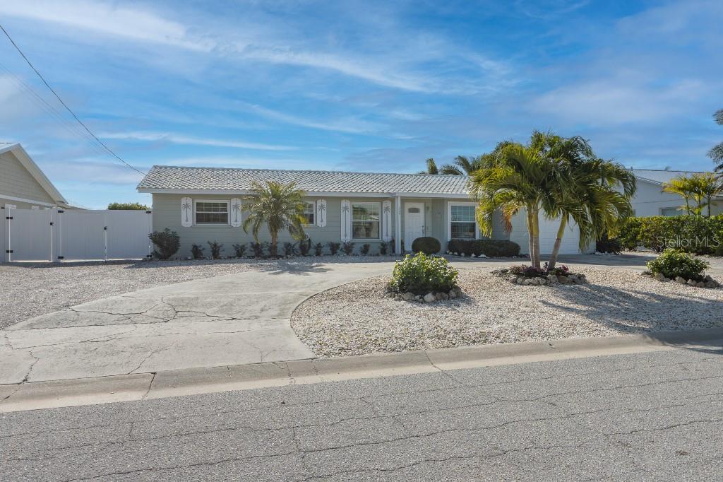 Welcome to your slice of island living in the heart of Holmes Beach. Perfectly positioned on a deep-water canal, this 2- bedroom, 2-bath ground-level home offers the ultimate Florida lifestyle for boaters and beach lovers. With a 60-foot dock equipped with water and electric, a 10,000 lb boat lift, you can launch your boat, kayak, or paddle board directly from your backyard.

Southern exposure bathes the property in warm natural light, making the winter months especially enjoyable while enhancing outdoor living year-round. Inside, the home is thoughtfully designed for comfort and efficiency, featuring Simonton Storm Seeker high-impact windows throughout, contributing to low maintenance and utility costs.

Step outside and enjoy island-style living with a covered pergola and patio, plus an enclosed outdoor shower to rinse off after a day on the water or at the beach, which is  three blocks away.

Whether you’re searching for a full-time residence, vacation home, or investment opportunity, this canal-front gem delivers the best of boating, beach access, and easy island living in one exceptional property.