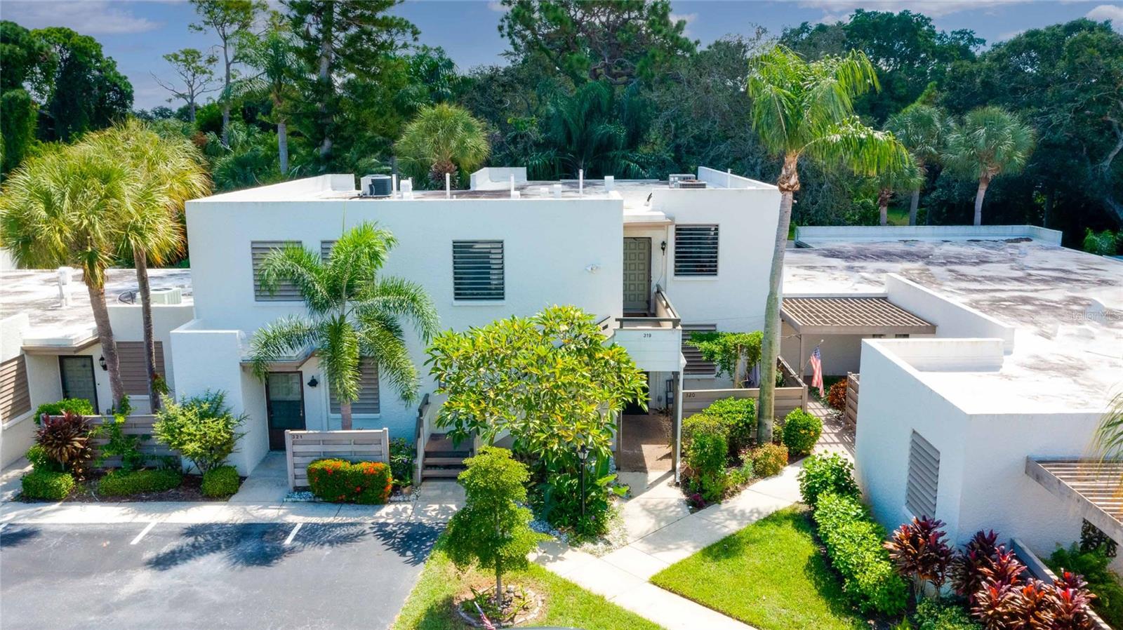 **PRICE REDUCED** Lowest price per square foot unit available. Welcome to Wildewood Springs the epitome of laid-back Florida Gulf Coast lifestyle. Tucked away in an 88-acre Audubon bird and wildlife sanctuary, yet conveniently located near all the retail and restaurants one could need. Only 6 miles to the award winning beaches of Anna Maria Island. This second floor 2 bedroom condo is one of the largest in the community at 1,408 sqft plus an extra 320sqft of living space on the enclosed lanai for a total of over 1,700 sqft under roof. The spacious lanai over looks a serene green space. The custom eat-in kitchen has easy slide cabinets, under sink water filtration system, stained glass doors and a stunning copper sink. The AC was replaced in 2021, water heater 2022, and the entire interior was just freshly painted. The rooms are all very spacious with no shortage of storage including 4 walk-in closets. This unit includes a coveted covered parking space; number 9. Wildewood has an abundance of amenities including 7 heated pools (the nearest is only 75 yards and includes a spa), tennis courts, pickle ball courts, kayak storage and a full calendar of activities. This community is open to all ages. Make an appointment for a private tour and start living your best maintenance-free lifestyle!