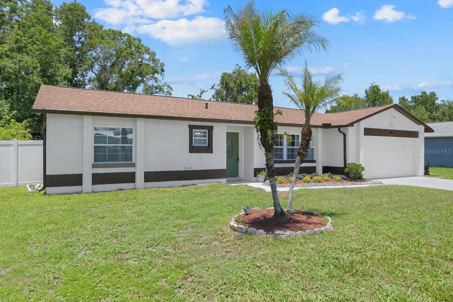 When we say "move in ready," we mean MOVE IN READY. You will be completely WOW'd the moment you open the door onto a beautiful open space with gorgeous vaulted ceiling and lots of natural light. Brand new luxury vinyl plank flooring in hushed tones, renovated white kitchen with quartz countertops, and stylish lighting make this home a truly exceptional value. The oversized 19'x14' primary suite has a large walk-in closet & updated bathroom, and truly feels like a sanctuary. In the backyard, enjoy a covered lanai and the many fruit trees & edible plants in the garden (mango, banana, cassava, elderberry, blackberries, blueberries). The 1/4 acre+ yard gives you plenty of space to spread out! Roof 2025, HVAC 2018, water heater 2019, exterior paint 2026 & updated plumbing provide added peace of mind. Download the list of features for more details on how amazing this home is. Schedule your showing today!