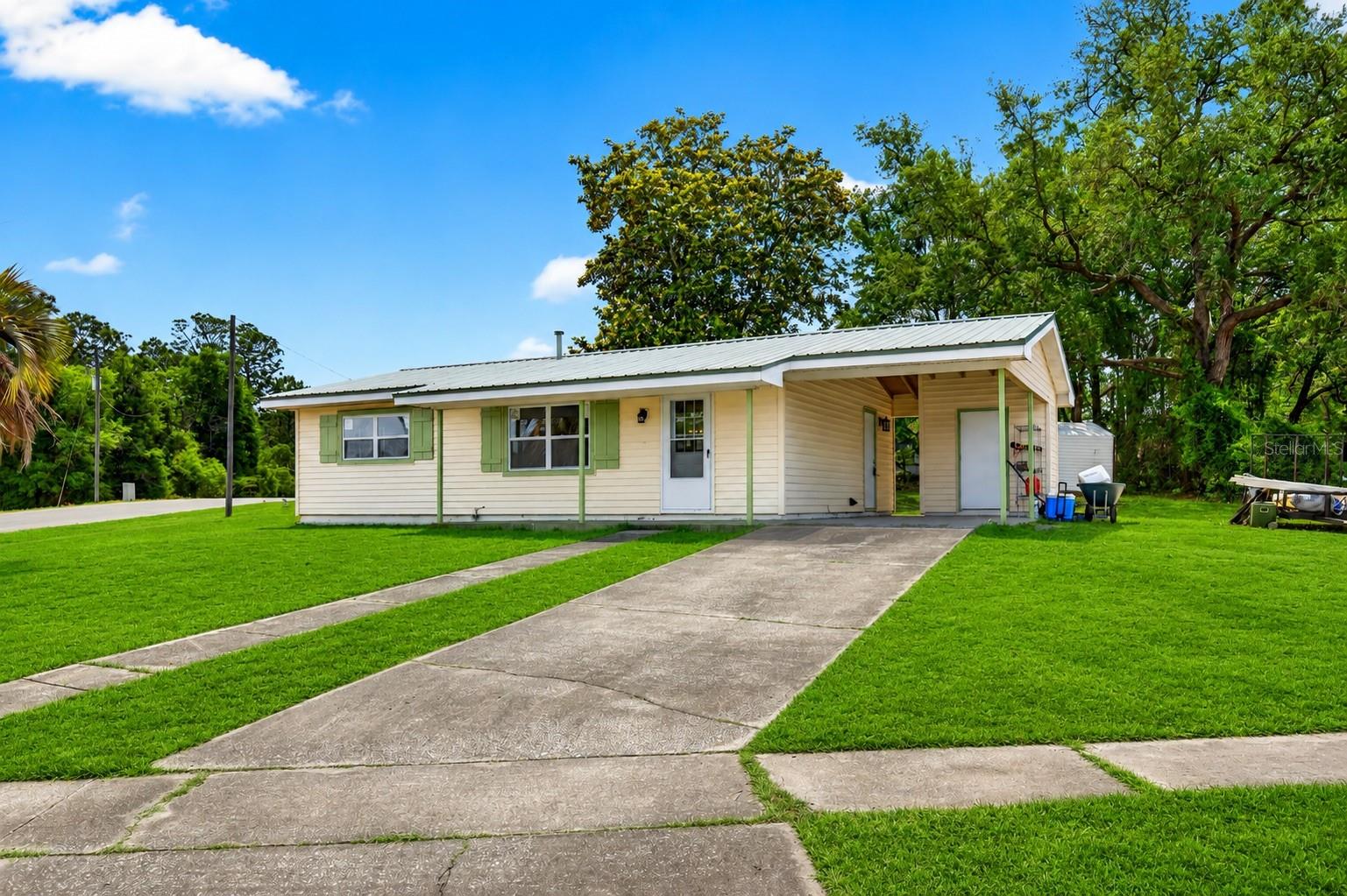 NEWLY UPDATED TOP TO BOTTOM — this home is truly move-in-ready! Welcome to this beautifully renovated home, situated on a high and DRY corner lot, located in the growing community of Citrus Springs offering modern updates, functionality, and move-in ready convenience. As you step inside, you’ll immediately notice the fresh interior paint, NO CARPET throughout, and bright open feel created by the brand new windows bringing in tons of natural light. The kitchen has been beautifully updated with brand new cabinetry, a farmhouse sink, and a clean modern design perfect for everyday living. One of the standout features of the home is the glass-enclosed back patio, creating the perfect additional living space for entertaining, relaxing, or enjoying your morning coffee year-round. Outside, the property features both a utility shed and an additional storage shed offering plenty of space for tools, lawn equipment, hobbies, or extra storage. here are also WASHER and DRYER hookups located on the interior of the property. A METAL ROOF was installed in 2016 for added peace of mind. Conveniently located near shopping, dining, parks, and everyday necessities while still offering the peaceful feel Citrus Springs is known for. This home is the perfect opportunity for a primary residence, seasonal home, or investment property. Don’t miss your opportunity to call this beautifully updated home yours!