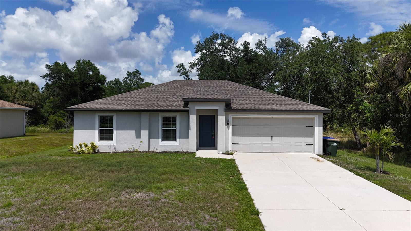 Built in 2022, this well-kept 3-bedroom, 2-bath, 2-car garage home in North Port combines modern comfort with an easy-living layout in a highly convenient location. From the moment you arrive, the home stands out with its tropical landscaping and inviting curb appeal, complete with a manicured lawn and colorful blooms that set a relaxed Florida tone. Inside, the home opens to a bright and airy great room with tall ceilings and a neutral color palette that enhances the natural light. Durable wood-look flooring runs through the main living spaces, offering both style and low-maintenance living that works well for pets and everyday life. The kitchen sits at the center of the home and connects seamlessly to the dining and living areas, making it ideal for entertaining or staying engaged with guests. It features granite countertops, ample cabinetry, a closet pantry, a breakfast bar, and comes fully equipped with appliances. The split-bedroom design offers privacy, with the primary suite set apart as a comfortable retreat. It includes a walk-in closet and private bath with a walk-in shower, vanity, and toilet. On the opposite side of the home, two additional bedrooms each include closets and natural light, with a shared guest bath featuring a tub/shower combination. Sliding doors open to a spacious backyard that’s ready for outdoor enjoyment, whether relaxing, gardening, or future enhancements. With no HOA or deed restrictions, you have the freedom to truly make the property your own. Conveniently located near Coco Plum Shopping Center, dining, golf, and everyday essentials, this home also offers easy access to the Gulf beaches including Boca Grande and Englewood. Outdoor recreation, boating, and fishing are nearby at Charlotte Harbor, and entertainment options include Charlotte Sports Park and the growing Wellen Park area with dining, shopping, and spring training baseball. Quick access to US-41 and I-75 makes travel throughout the region simple. A move-in ready home in a prime location—ready for its next chapter.
