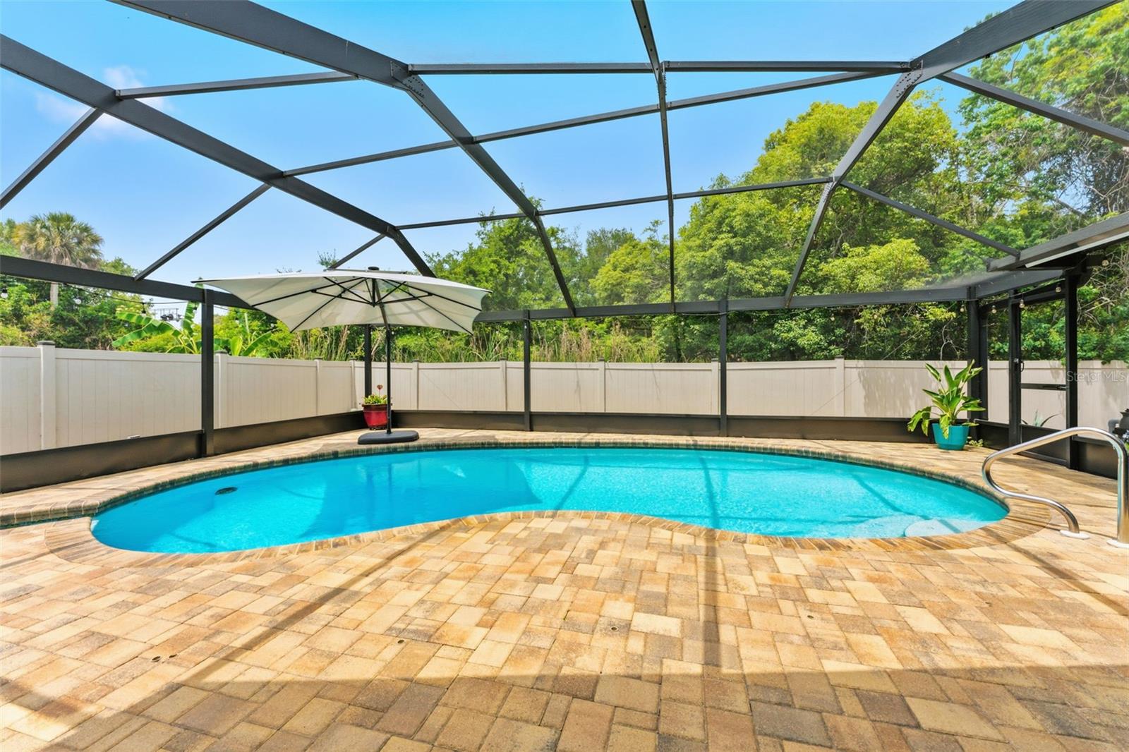 Do your changes in latitudes and changes in attitudes have you searching for a new Florida home? You don't have to be a Parrot Head to want to grill your weekend cheeseburgers in paradise. This Safety Harbor home blends fun outdoor entertaining spaces with desirable indoor living functionality. The incredible open floor plan will inspire enjoyable every-day living and level up any social gathering whether it be your your summer BBQ's or winter soiree's. Let summer fun begin in the salt-water pool under a shady pool umbrella, a 3-person Hot Spring Hot Tub, and a pass-thru window from the kitchen to the patio pool deck for that Pina Colada. Numerous unexpected extras include: PGT Hurricane Impact Windows, New Roof 2026, HVAC 2020, Hot Water Heater 2022, New Ductwork, New Blown-in Insulation, a custom leaded glass front door from “Artistic”,  Electric Fireplace, Stamped Concrete Driveway/Patio, Reverse Osmosis Echo, New Garage Door Opener and a New Pool Cage 2020.  Boasting of 4 true bedrooms in a split-floorpan configuration, this home also offers a spacious indoor laundry room complete with washer/dryer and sink basin. Every upgrade has already been made whether it be the fully renovated bathrooms, open-concept kitchen or the continuous wood-look tile floor throughout all living areas. Situated on a private lot with no rear neighbors, this home is easily golf-cartable to downtown Safety Harbor for the morning coffee run, all of the weekend festivals, and the social food/drink/boutique ambiance that this Hallmark town has to offer. A Safety Harbor location that cannot be beat, you'll be a quick bike ride to Philippe Park or downtown waterfront park where you can take in the small-town atmosphere and walk the boardwalks among the mangroves. This home is not just a home, it’s an invitation to a new lifestyle! Schedule your showing today because come Monday, it could be too late!!!