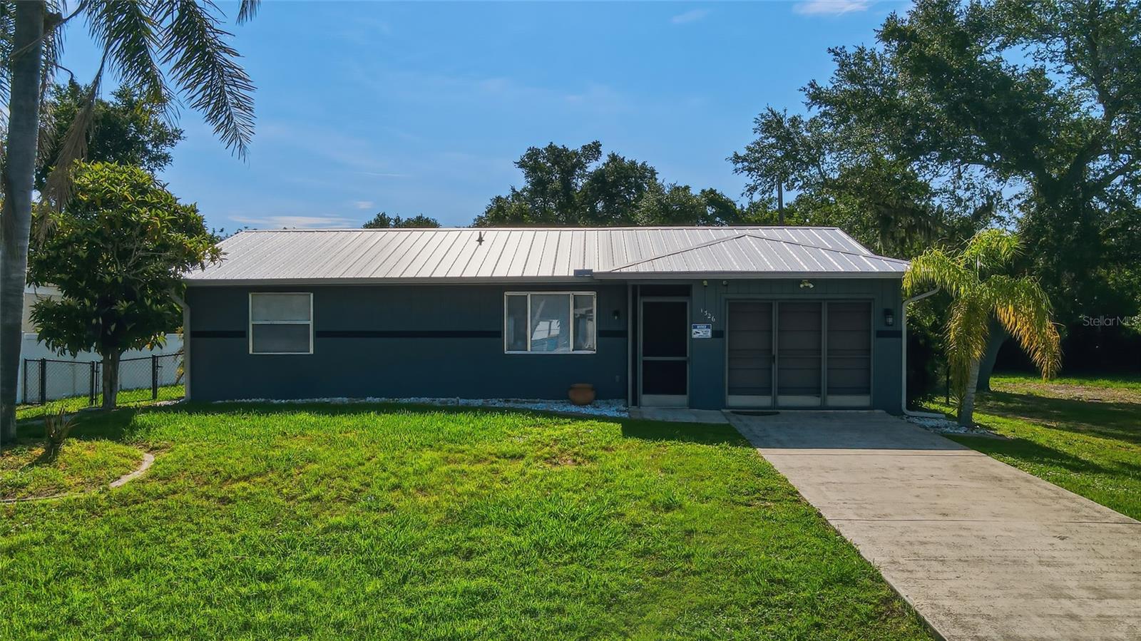 Rare opportunity to own a well-maintained home with an additional adjacent lot included in the sale, providing approximately .46 acres of total property and added privacy, space, and future possibilities. Situated in a convenient Port Charlotte location, this property offers room to spread out both inside and out.

Recent major updates include a durable metal roof installed in 2022 and a new A/C system in 2023, helping provide peace of mind for years to come. The home also features a newer water heater, a large enclosed lanai/sunroom perfect for year-round enjoyment, and a fully fenced backyard ideal for pets, entertaining, or simply enjoying the extra outdoor space.

A spacious storage shed offers plenty of room for tools, equipment, hobbies, or additional storage needs. With the included neighboring lot, there's ample space for boats, RVs, gardens, a future pool, or simply maintaining the privacy that is becoming increasingly difficult to find.

Whether you're looking for a primary residence, seasonal retreat, or investment opportunity, this property offers exceptional value with significant land, important system upgrades, and room to grow.