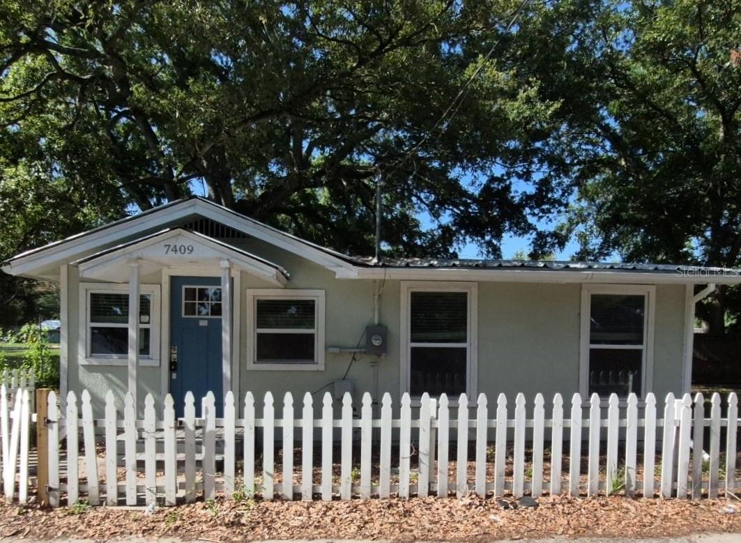 Another wonderful opportunity to own this value priced and simply adorable bungalow. This home welcomes you with charm, comfort, and endless potential! This quaint 2-bedroom, 2-bath detached home offers a large, fenced yard with a personal driveway, shade trees and a front porch. Updated with laminate floors throughout and an updated kitchen and bath. The property also offers central air and oversized bedroom closets. Inside, you’ll find an open-concept floor plan, a breakfast bar, updated cabinetry, appliances, and a laundry closet with washer and dryer included. Just minutes from Florida State Fairgrounds and within close proximity to waters of Hillsborough Bay and the Tampa Canal.