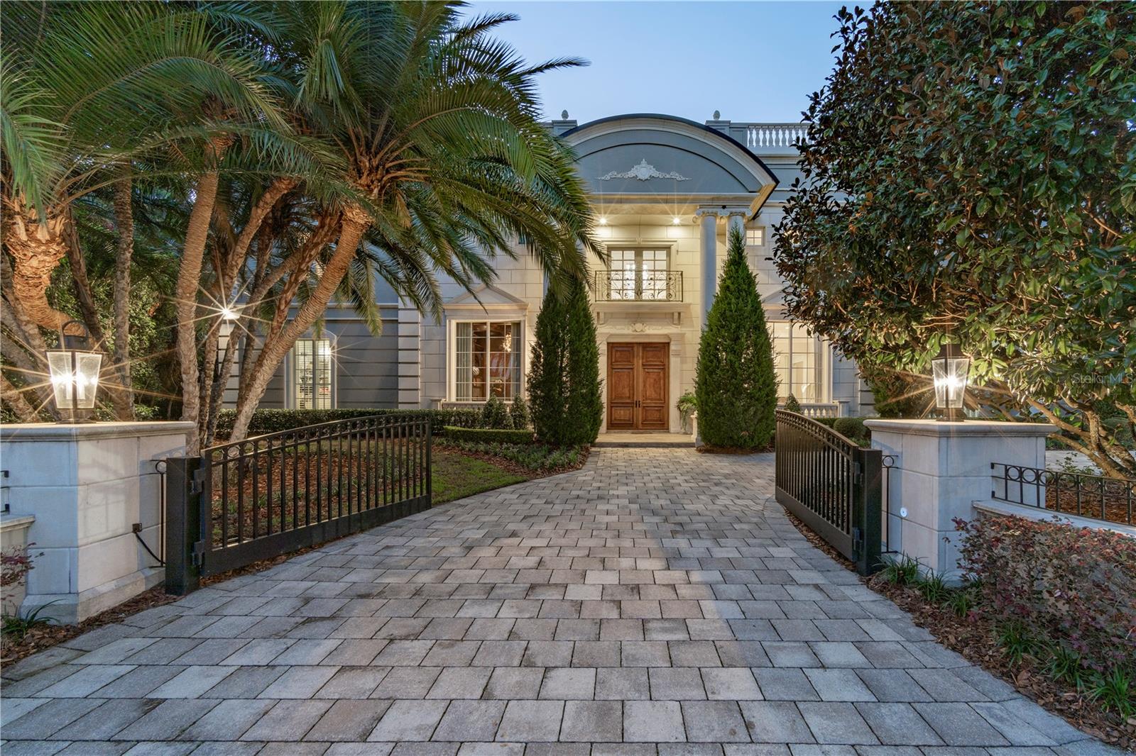 Elegant French Mediterranean gated lakefront estate on premier exclusive and private setting in Olde Winter Park… Extremely RARE opportunity to  purchase a spectacular residence located on the Isle of Sicily (only 11 homes on this exclusive island) with dramatic water views on both sides of the property to enjoy sunrises and sunsets across Lake Maitland (largest lake on the 6-lake chain of lakes). This property is a one owner custom built home resting on approximately 3/4 acre upland (1.41 total acres per tax records) of property secluded on a private island off the Via’s neighborhood inclusive of the Winter Park Racquet Club walking/boating distance away… This custom-built residence was completed only 9 years ago with wonderful bright-open floor plan and flooded with light from extensive walls of glass… The interiors are not only light, but sleek, modern, and tastefully decorated with gorgeous lighting, extensive moldings and top-quality craftsmanship that will captivate you from the moment you enter the grand foyer looking straight through the 2-story living room to breathtaking views of the pool, grounds & lake...  Additionally, downstairs you will enjoy a private library, formal (but open) dining room, fabulous chef’s island kitchen with Sub-Zero, Thermador Italian ILVE appliances including a casual dining area open to the lakeside gathering room with masonry fireplace, plus wine room along with the lavish primary owner’s quarters including a “Four Seasons” spa-like bath & his/her dressing areas, bar with refrigerator, fireplace & steam room… Upstairs commences with a stunning winding stairwell of glass panels taking you up to an expansive, open lounge area with curved corner bar and separate billiards are all open to the lakefront terrace… Plus, 3 flexible rooms: currently utilized as a media room, massage room, and exercise room… As well as a junior oversized guest suite and three more bedrooms all with private en-suite baths… The outdoor lakefront living includes majestic Cypress trees, expansive covered lanai, summer kitchen, tropical heated salt pool and spa with beach entry, fiberoptic lighting, fire bowls & fountain, a dedicated fire pit seating area, complete boathouse & more… Other notable features include an elevator, 5 masonry fireplaces, 2 separate laundry rooms up/down, 2 dishwashers, butler’s pantry, wine room, Control4 home automation, 4 zoned AC systems, termite bond, lake irrigation, dedicated outdoor pool bath, “oversized 4-car garage”, automatic gated circular drive entry, & more…