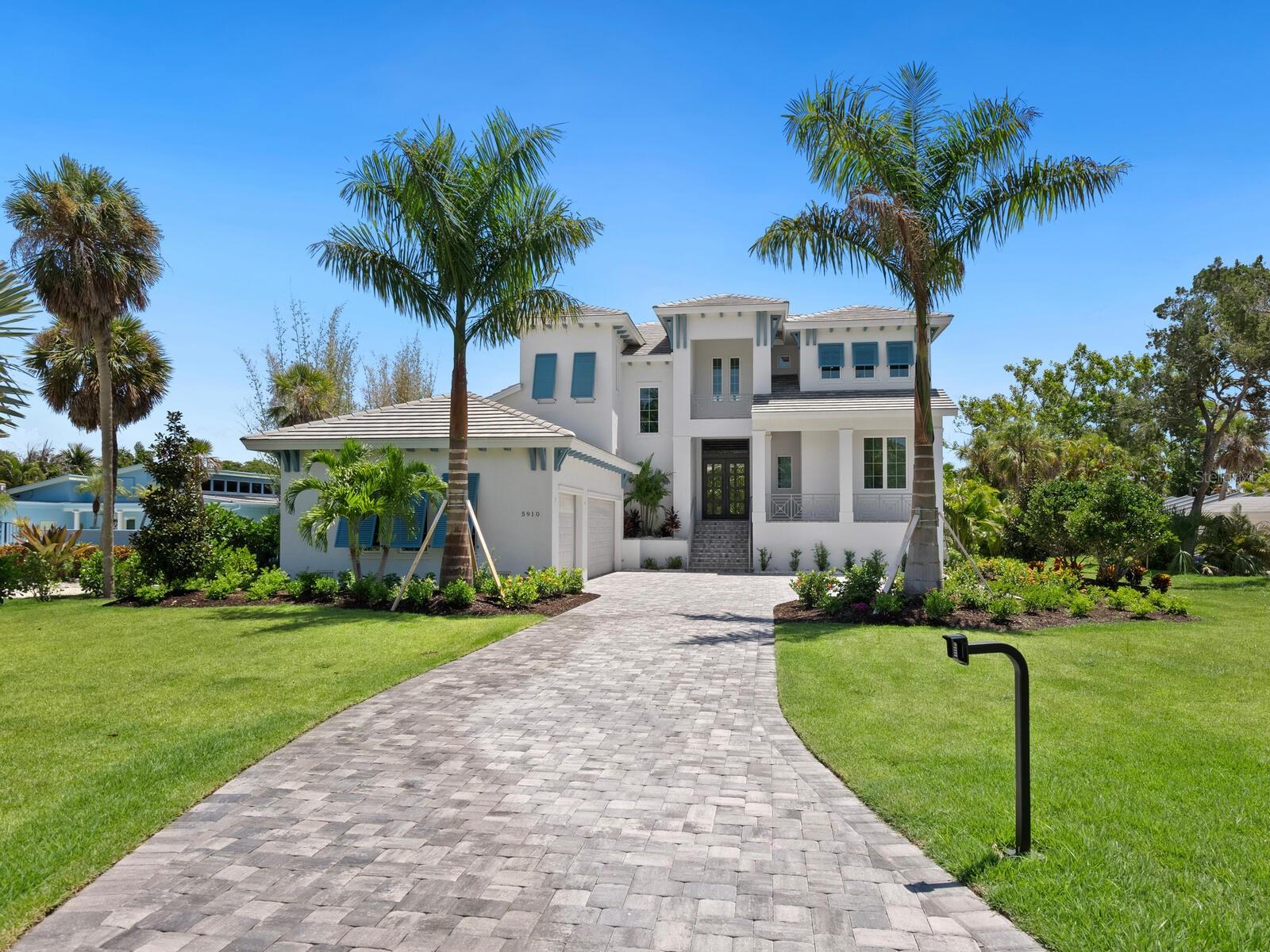 Live the boater’s dream on exclusive North Longboat Key. This spectacular, newly built, coastal contemporary waterfront home provides easy access to the tranquil Intercoastal Waterway, sparkling Sarasota Bay and majestic Gulf of Mexico. Located on a three-quarter acre lot with 133 feet of frontage on a 125-foot-wide canal, this 4,210-SF home features an open floorplan with light-color finishes, quartz hard surfaces and wood-look tile flooring. The large kitchen includes a Sub-Zero glass door refrigerator and Thermador appliances. There is an additional full outdoor kitchen with a gas grill, vent hood and U-Line refrigeration. A spacious first-floor office/den overlooks the waterway. There are 5 ample en-suite bedrooms, 2 half-baths. Relax in the second-floor master suite Jacuzzi tub or take the spiral staircase up to the third-floor observation deck to relish the serene views. The large, heated pool includes a Jacuzzi with a sun shelf for year-round enjoyment. During the cooler months, enjoy a relaxing evening in the great room in front of the fireplace or outdoors near a mesmerizing fire pit. Additional luxury amenities include a 60-foot composite deck with a 10x10 sitting area, fish station, water spigots on dock, bumpers, cleats and underwater lights. Water safety features include a new 133-foot seawall raised 13 and vinyl panel fronts on the 125-foot-wide canal. Make use of the two boat lifts – one 20,000-lb. and one 15,000-lb. and an additional Jet Ski spinner lift to delight in a fun-filled day on the water. This stunning home is ideally located near St. Armands Circle, pristine beaches, fine dining and specialty boutique shops. With professionally landscaped grounds, electric drive security gate and easy access to the bay, this luxurious property is perfect for discerning devotees of the boating lifestyle. This property, along with the beachfront property across the street can be sold together.