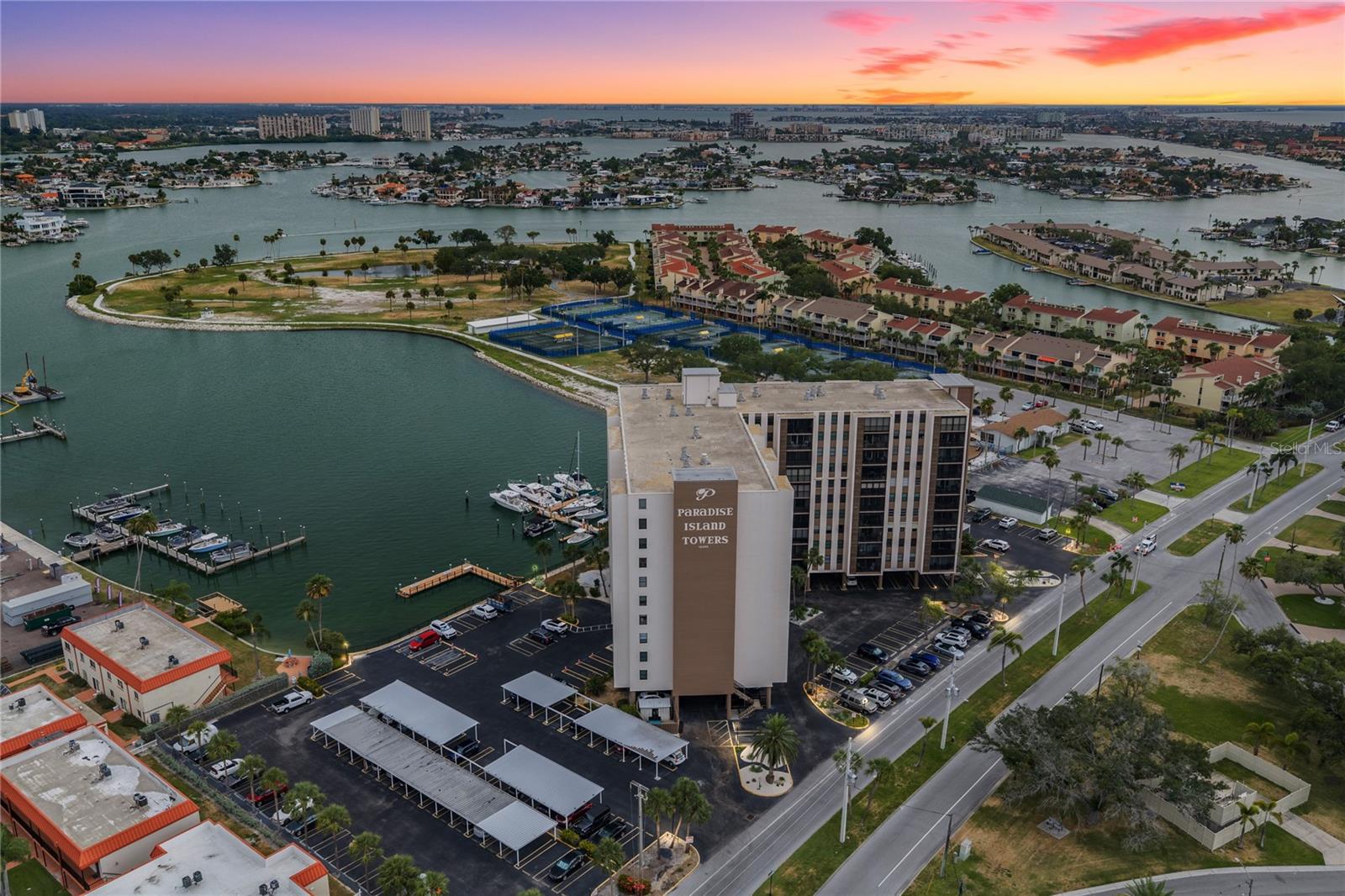 Welcome to your own slice of paradise at 10355 Paradise Blvd, nestled in the highly sought-after Paradise Island Towers community in Treasure Island. This beautifully positioned corner-unit condominium offers breathtaking panoramic views of both the sparkling Gulf of Mexico and the tranquil Intracoastal waters, creating the perfect backdrop for morning coffee, evening cocktails, and unforgettable sunsets. Natural light fills the living spaces thanks to the desirable corner location, while the ever-changing water views provide a sense of peace and relaxation that's hard to find. Situated on the 4th floor, this residence remained high and dry with no damage from recent hurricanes, offering added peace of mind and showcasing the strength of its elevated location. Paradise Island Towers is known for its outstanding waterfront amenities and resort-style atmosphere. Residents enjoy a heated waterfront pool, fitness center, clubhouse, fishing dock, kayak and paddleboard launch, shuffleboard courts, barbecue area, and beautifully maintained grounds, all designed to make every day feel like a vacation. The location is second to none. Just minutes from the sugar-sand beaches of Treasure Island, you'll love being able to bike to the beach, stroll along the waterfront, explore local restaurants, boutique shopping, waterfront parks, and enjoy some of Florida's most spectacular sunsets. Whether you're looking for a full-time residence, a seasonal retreat, or the perfect place to embrace the coastal lifestyle, this home offers the ideal combination of comfort, convenience, and breathtaking scenery. Don't miss this rare opportunity to own a corner-unit waterfront condo in one of Treasure Island's most desirable communities, where every day feels like a vacation.