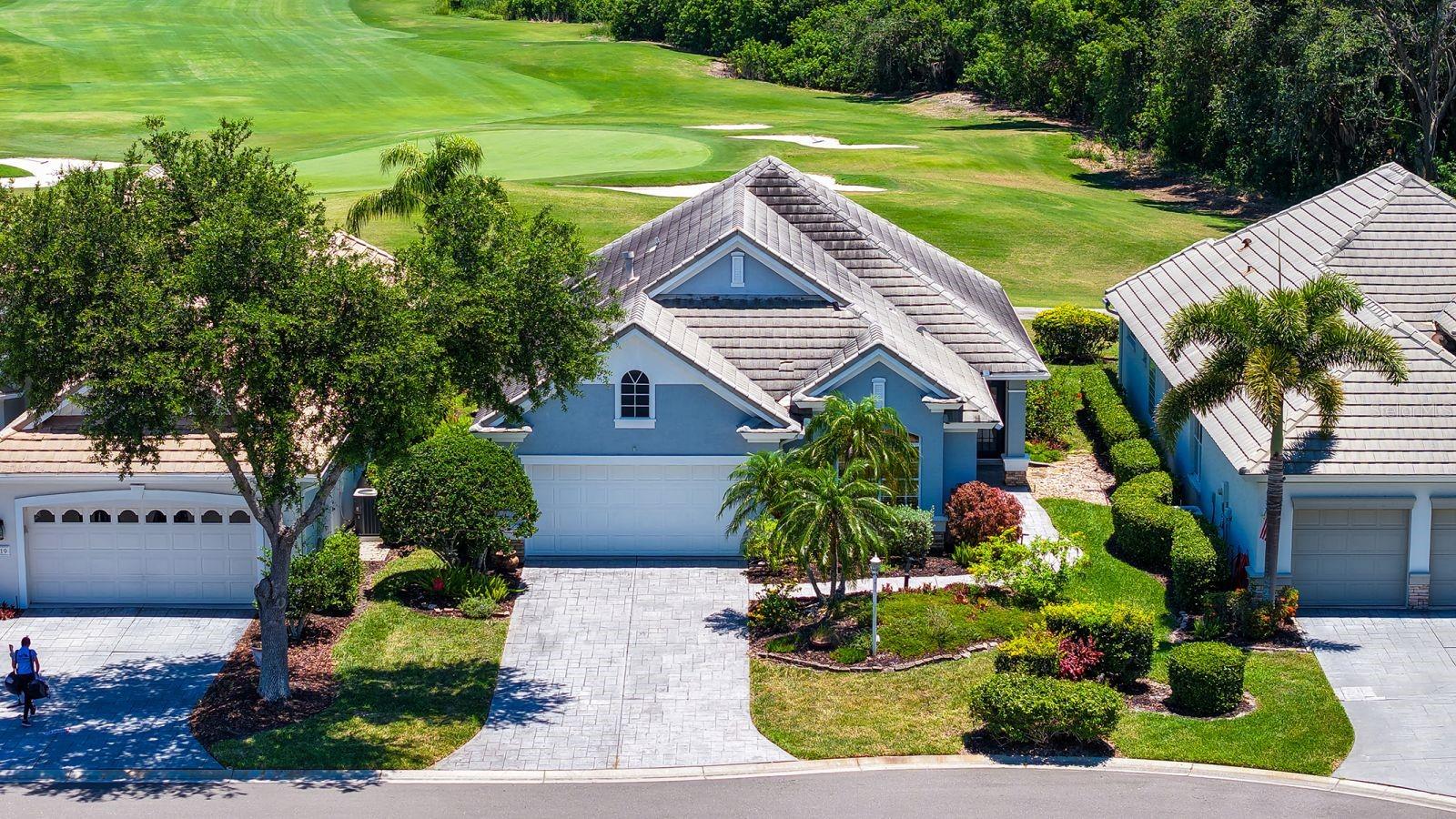 Perfectly positioned on a premium homesite overlooking the lush fairways of Legacy Golf Course, this beautifully updated residence in Lakewood Ranch Golf & Country Club offers the ideal blend of privacy, comfort, and effortless Florida living. Tucked away on a quiet cul-de-sac in the maintenance-free enclave of Muirfield, you’re just moments from the community pool, spa, and resident clubhouse, with Main Street’s shops, dining, cinema, and vibrant events only a short stroll or bike ride away. Step inside and experience a bright, open great room design enhanced by soaring 12-foot ceilings, abundant natural light, and new luxury vinyl plank flooring throughout. The thoughtfully updated kitchen showcases striking white and navy cabinetry, quartz countertops, and stainless steel appliances, seamlessly connecting to both the main living areas and a charming private patio—perfect for morning coffee or intimate gatherings. Wall-to-wall sliders invite you outdoors to an extended lanai where a heated spa and sweeping golf course and preserve views create a true retreat. The owner’s suite is a serene escape, complete with a sitting area, French doors to the lanai, a walk-in closet, and a beautifully updated bath with soaking tub and walk-in shower. Additional features include plantation shutters, remote-controlled shades, a spacious guest suite for visiting family and friends, and a versatile den that easily functions as a third bedroom or home office. A formal dining room with French doors adds another layer of charm and flexibility for entertaining. Located behind the gates of one of the nation’s most sought-after master-planned communities, this home places you just a short drive from world-renowned Gulf beaches, downtown Sarasota’s cultural scene, and the UTC shopping district. Experience refined, maintenance-free living in a setting that truly has it all.