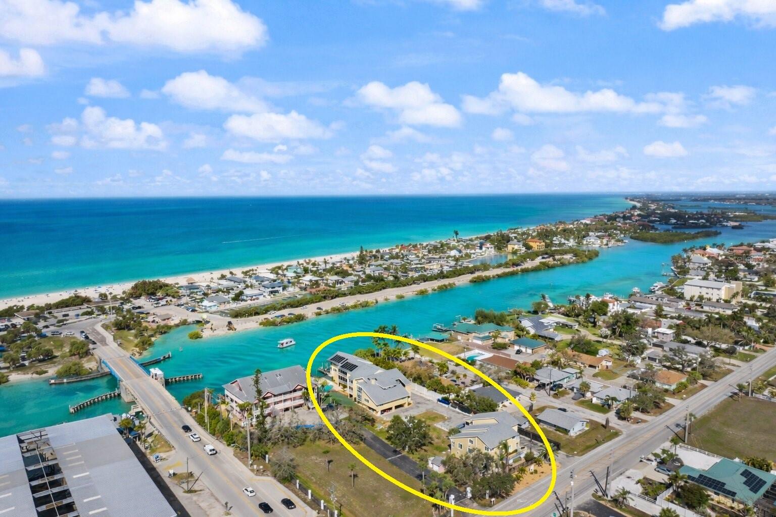 $59k PRICE IMPROVEMENT & REMODELED—Discover one of the best turnkey coastal values just moments from Nokomis Beach & the Venice Inlet, where sunsets, dolphins, & the relaxed beach lifestyle are part of everyday life. This beautifully refreshed & professionally decorated turnkey furnished coastal residence places you in the heart of Nokomis Beach, where bicycles, golf carts, & flip-flops are often the preferred way to get around. Located within a small, gated waterfront community just one block from Nokomis Beach, this residence offers the ideal combination of beach living & everyday convenience. The open great room floor plan features soaring vaulted ceilings & includes two bedrooms, two bathrooms, & an expansive loft-style primary suite occupying the entire third level. The coastal inspired interior includes granite countertops, wood cabinetry with under lighting, new light fixtures, furnishings, area rugs, updated guest vanity, & freshly painted interior. Plantation shutters & walls of glass fill the space with natural light, while sliding glass doors lead from the great room to the balcony. The private primary retreat spans approximately 522 square feet & features a spacious bedroom area, oversized walk-in closet, & ensuite bath with dual sinks, garden tub, separate shower, & private water closet. The guest suite is conveniently located on the main living level with its own private bath that also connects to the hallway. A large bonus/flex room on the ground level offers incredible versatility with sliding glass doors opening to the lawn area. This space can function as a third bedroom, game room, art studio, fitness space, or additional living area, while providing excellent storage for beach gear, bicycles, kayaks, paddleboards, & fishing equipment. It also includes a spacious laundry area with cabinetry, double utility sink, & extended countertop workspace. Three covered parking spaces are located beneath the building. Residents enjoy a beautiful waterfront pool, spacious sun deck, & covered cabana lounge overlooking the docks & passing boats traveling the Intracoastal Waterway toward the Venice Inlet. Boat docks line the waterfront & are individually owned within the community, with occasional opportunities to privately rent a slip. Historic Downtown Venice Island is only minutes away with boutique shopping, dining, festivals, & farmers markets, while Sarasota & world-famous Siesta Key are an easy drive. Life here is wonderfully simple: a one-block walk to the beach, bike rides to waterfront dining, cruising the golf cart through this charming coastal village, & days spent surrounded by dolphins, warm breezes, & the beauty of the Gulf. During the day, the surrounding waters come alive with dolphins, gentle manatees, osprey diving for their catch, colorful coastal birds gathering along the sandbars, & a steady parade of boats, jet skis, & kayaks. Imagine ending your day with a short walk or golf-cart ride to Nokomis Beach to watch the sun melt into the Gulf of Mexico as the sky fills with spectacular sunset colors. As evening settles in, stroll to nearby favorite waterfront restaurants or tiki bars where world-class musicians perform nightly & enjoy fresh coastal cuisine while soaking in the beach village energy that makes this area so special. Here, you can truly leave the car behind & embrace the relaxed coastal lifestyle the way you were meant to live it. Because here, Nokomis Beach is not just a place… it’s a state of mind.