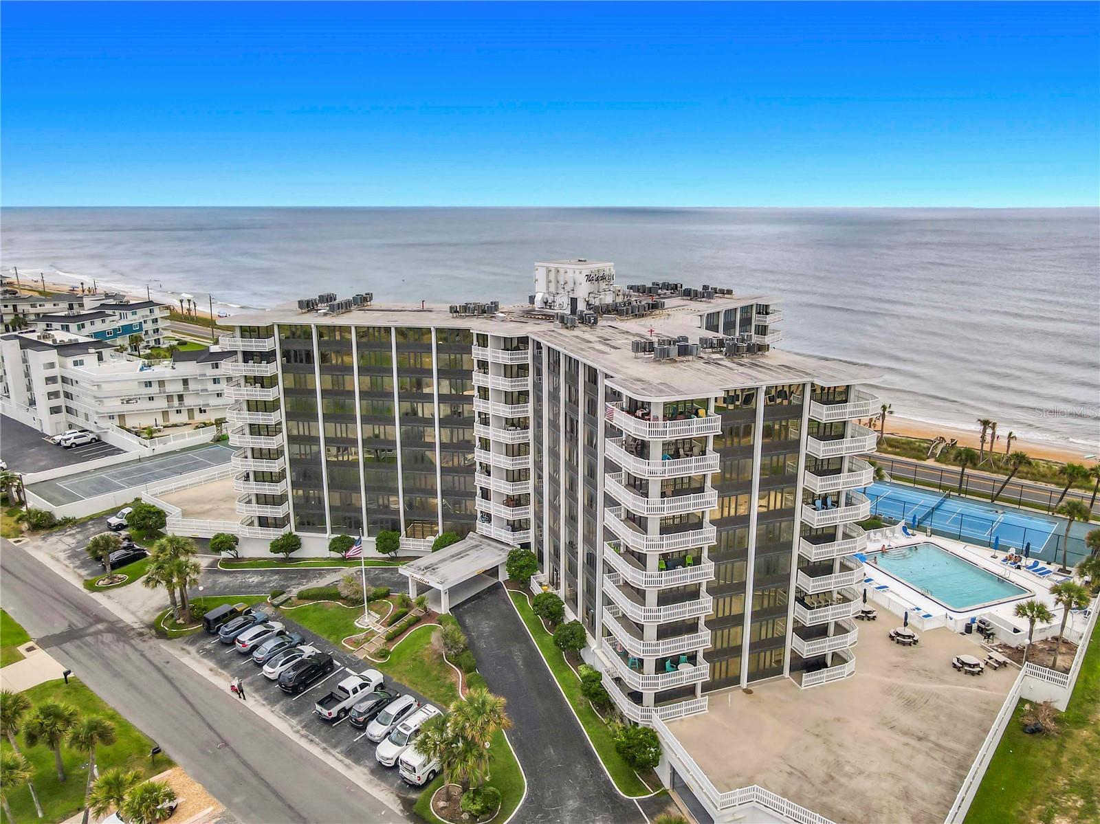 Experience the ultimate beachfront lifestyle at the Nautilus Condominium in beautiful Flagler Beach! This stunning 5th-floor corner unit offers breathtaking panoramic views of the Atlantic Ocean and the soothing sound of waves from nearly every room. Featuring 3 spacious bedrooms and 2 beautifully remodeled bathrooms with custom tile and upscale finishes, this exceptional residence is designed for both comfort and coastal elegance.

The fully equipped kitchen opens seamlessly to the living and dining areas, creating the perfect space for entertaining while enjoying endless ocean views. Step outside onto the expansive wraparound balcony and take in spectacular sunrises, refreshing sea breezes, and unobstructed beachfront scenery.

Thoughtful upgrades and features abound, including built-ins throughout the condo, a brand-new dishwasher, updated lighting, new window shades, removed popcorn ceilings in the living area and hallway, a tankless hot water heater, and a newer A/C system just two years old. One of the few units in the building offering a washer and dryer hookup, this condo combines convenience with luxury.

The spacious primary and guest bedrooms each enjoy ocean views, while the second bedroom features double closets and the third bedroom offers additional built-in storage. Being sold turnkey, this residence includes custom bedroom suites and a sleeper sofa, making it ready for immediate enjoyment or vacation rental potential.

Residents enjoy secured underground deeded parking, dedicated storage rooms, bike racks, a community pool, tennis and pickleball courts, and easy access to a nearby 9-hole golf course. Whether you're seeking a full-time residence, vacation retreat, or investment opportunity, this oceanfront gem delivers the very best of Flagler Beach living. Wake up to the Atlantic, spend your days enjoying the beach, and embrace the coastal lifestyle you've always dreamed of!