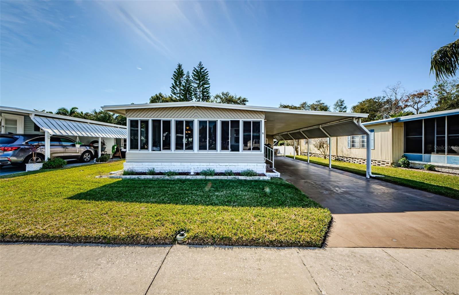 Welcome to your Florida retirement dream home in the highly desirable Stonehedge on the Hill 55+ community—where you OWN THE LAND and enjoy resort-style living with NO LOT RENT! This fully furnished, move-in ready 2-bedroom, 2-bath manufactured home offers comfort, value, and an unbeatable Tarpon Springs location near beaches, golf, shopping, restaurants, medical facilities, and the famous Tarpon Springs Sponge Docks. This spacious and meticulously maintained home features a bright open floor plan filled with natural light, plus a large 182 sq. ft. Florida Room perfect for relaxing, entertaining, or enjoying Florida’s year-round sunshine. A newly installed sliding glass door enhances the indoor-outdoor flow and brings even more light into the living space. The fully equipped kitchen offers abundant cabinet storage, a closet pantry, washer and dryer, and all appliances included. The dining area features a charming built-in buffet, cabinets, and bookcase for added functionality and style. The oversized primary suite includes dual closets, built-in dresser and desk, and a private ensuite bath with a step-in shower. Guests will appreciate the spacious second bedroom and beautifully updated guest bath with another step-in shower. Recent upgrades provide peace of mind and energy efficiency, including a new AC and heating system (2024), new sliding glass door, double-pane windows (2012), new siding (2012), high-quality laminate flooring in the living areas, an expanded 2+ car carport, storage shed, and well irrigation system. Low HOA fees of just $380/month include water, sewer, trash and recycling, lawn maintenance, basic cable with 70+ channels, internet, and pest control. Residents of Stonehedge on the Hill enjoy an active Florida lifestyle with amenities including a heated pool, clubhouse, library, shuffleboard courts, game rooms, social events, and community activities. Convenient side gate access to Mango Street makes it easy to reach Fred Howard Park, Sunset Beach, and the Tarpon Springs Golf Course. Conveniently located near two major airports, approximately 22 miles to Tampa International Airport and 18 miles to St. Pete–Clearwater International Airport, this home offers the perfect balance of relaxation and accessibility. If you are searching for an affordable Florida retirement home, land-owned manufactured home in Tarpon Springs, seasonal residence, or full-time 55+ living near the Gulf beaches, this exceptional property checks all the boxes. Schedule your private showing today!