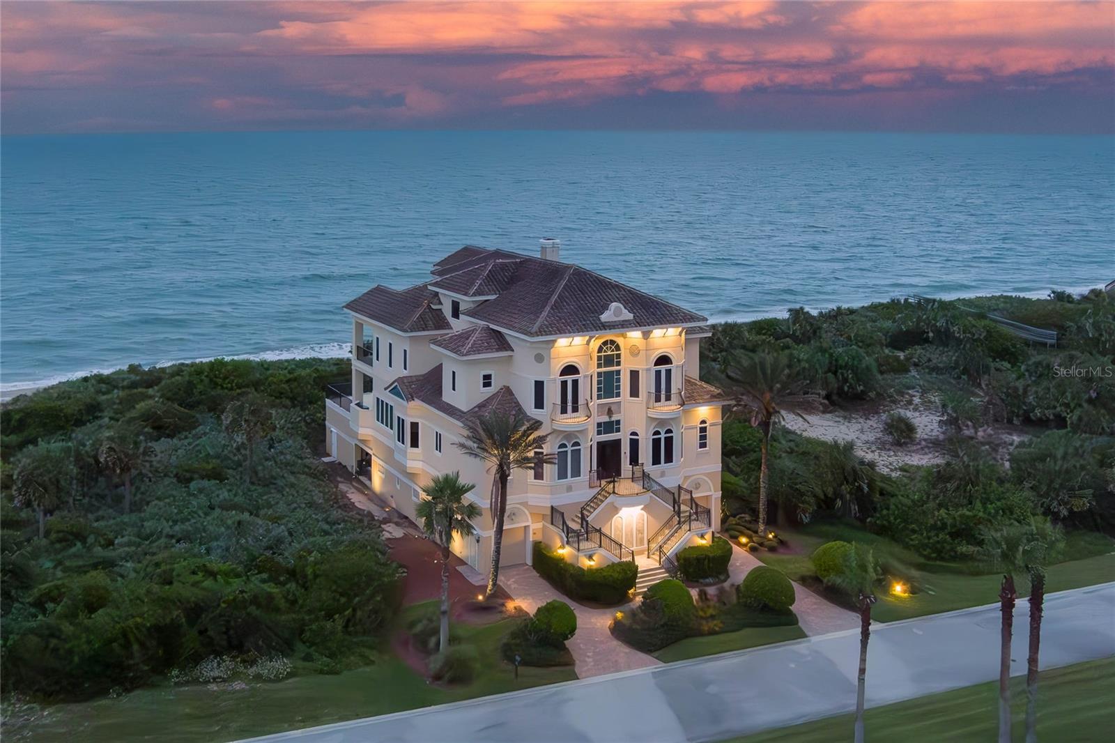 This estate offers four levels of luxurious everyday living and entertaining with 180-degree unobstructed views of the Atlantic.  A double-barreled imperial staircase welcomes you into the airy main level, defined by a soaring great room and kitchen. Walls of oversized windows and French doors ensure that you are always close to a sea or lake view inside the property connecting seamlessly to the outdoors. The main living and outdoor terrace sit on the second level of the four-story estate, your views extend to the horizon. A swimming pool and spa offer a centerpiece for gatherings on the terrace, while a private dune walkover whisks you down to the beach. Host a gathering indoors or out. A home theater, billiards room, along with wine cellar and adjacent tasting room provide options for every entertaining style. A full gym, plus separate massage and serenity rooms provide a private, in-home resort experience. Your owner’s suite is a true sanctuary, set apart on its own floor. Whether you unwind with a soak in your tub or lounge on your private balcony, you’ll revel in the blue expanse, extending as far as the eye can see. With seller contribution for equity membership available, Hammock Dunes Club is so much more than a private, oceanfront country club. Its superior member experiences have earned it the prestigious Distinguished Emerald Club of the World recognition. Two eighteen-hole, championship golf courses: The Hammock Dunes Links Course designed by Tom Fazio and the pristine Creek Course designed by Rees Jones, located in a 690 acre nature preserve. Five Har-Tru tennis courts and Racquet Sports Pro Shop, Four new Pickleball courts. Full Racquet Sports Program. Resort Style 25-meter outdoor swimming pool and spa, heated year-round, with children’s Splash Pad, Food Service and Playground. A 5,500 sq. ft., Oceanfront Fitness Center with Lifefitness cardio machines, free weights, personal training, Les Mills virtual training and 40 live group classes offered per week. Four Bocce courts with an active seasonal league program. The Oceanfront Links Clubhouse features the Dunes Tavern indoor/outdoor dining and open concept kitchen. The intimate Low country-style Creek clubhouse is nestled in a natural setting and includes dining facilities, bar, screened porch, golf shop and cart facility.