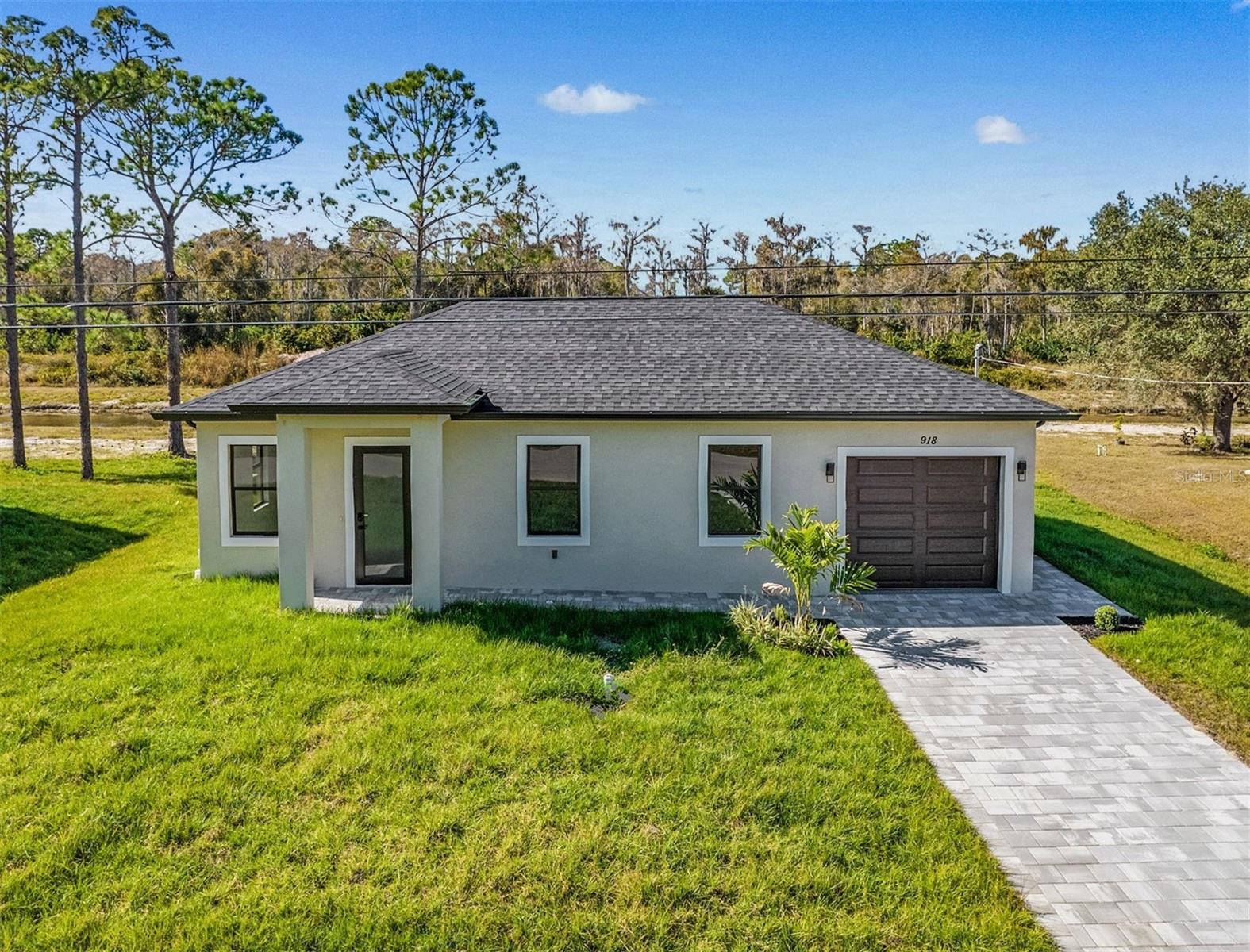 Brand-New Construction**Be the First to Live in this Gorgeous New Home *Seller willing to provide up to 10k toward Buyer's Closing Costs **Modern 3 Bedroom, 2 Bath Home with attached Garage on a Spacious Lot. *Beautiful oversized Modern Tile throughout for easy care; and Impact Rated Windows throughout to enjoy amazing Florida Sunshine! The Gorgeous Kitchen has Custom Cabinetry, Quartz Countertops, Stainless-Steel Appliances & Designer Lighting right out of a magazine! *Spacious Luxe Bathrooms feature beautiful Cabinetry & Roomy Showers like a Spa! This home sits on a Spacious Lot, Ready to Enjoy with your Family, Friends, & Pets, for BBQ's, Gatherings, & More!
