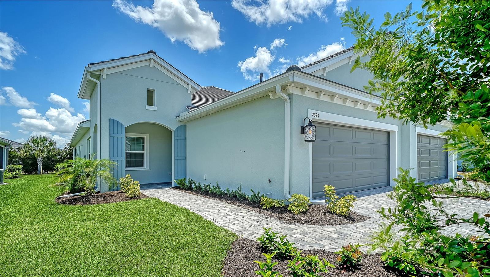 This move-in ready villa offers 1,530 square feet of living space with wood-look tile flooring throughout. The great room features a recessed ceiling and pocket sliding glass doors that open to an extended lanai with a gas stub for a future grill and views of the community greenspace. The kitchen is appointed with quartz countertops, brushed gold hardware, soft-close cabinetry, and a gas slide-in range. Impact-resistant glass windows, along with the low-maintenance lifestyle of villa ownership, add to the home's appeal. Community amenities include a clubhouse with a full-time activities coordinator, two swimming pools, a tot lot, dog parks, and more than five miles of walking trails.