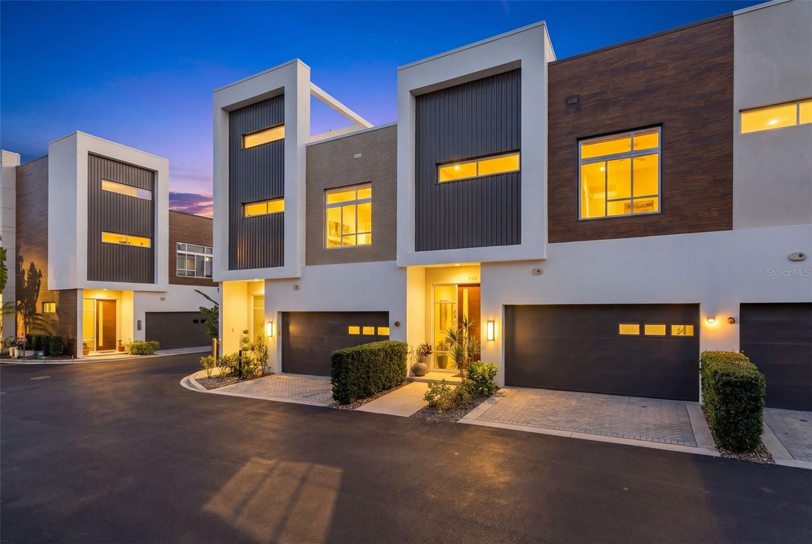 Discover contemporary luxury at its finest in this impeccably designed downtown Sarasota townhome—a  sanctuary just steps from the vibrant energy of Main Street and serene Bayfront Park.This stunning two-bedroom, two-and-a-half-bath residence seamlessly blends refined elegance with effortless modern living. Enter to be greeted by exquisite finishes: sleek Lube Italian cabinetry, Caesarstone quartz countertops and backsplash, soaring eight-foot imported Rosewood doors, and premium Bosch appliances anchored by a gas 5-burner cooktop. Hansgrohe fixtures, a whole-home Culligan filtration system, and tankless hot water elevate every moment to spa-like indulgence. Thoughtful luxury extends throughout: a private two-car garage, custom California closets, and your own two-stop elevator for effortless access between levels. Two generous terraces—one with a gas hookup—invite al fresco dining, sunset gatherings, or quiet evenings beneath the stars, with custom retractable screens enhancing the flawless indoor-outdoor connection. Bathed in natural light, the open-concept layout is ideal for both grand entertaining and peaceful retreats. Location is everything, and this home delivers. Stroll to world-class dining, boutique shopping, and cultural venues, or drive mere minutes to the powdery sands of Lido Beach, Longboat Key, and legendary Siesta Key—consistently ranked America’s #1 beach. Sarasota-Bradenton International Airport is only 15 minutes away for easy travel.
More than a home, this is an elevated Sarasota lifestyle, convenient, and undeniably captivating. Schedule your private showing today and step into the life you deserve.