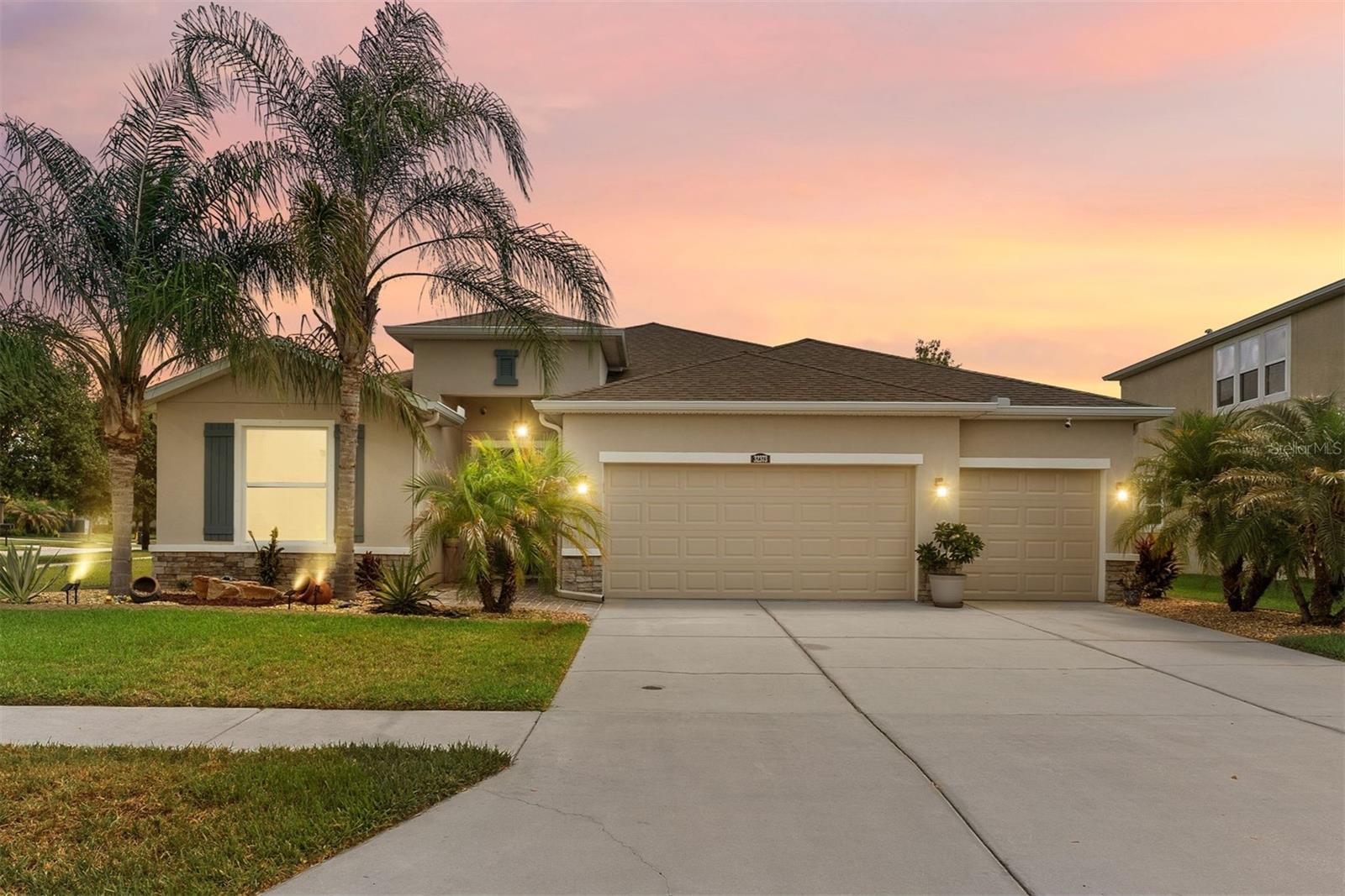Welcome to beautiful Union Park in Wesley Chapel, where this stunning single-story home is one of only two with this highly sought-after floor plan. Offering nearly 2,600 square feet of interior living space, you'll find four bedrooms, including two primary suites, a luxurious kitchen, and 3.5 baths including an owner's ensuite bath you have to see to believe; you'll also enjoy a 3-car garage, large covered lanai, and a fully fenced backyard all situated on an oversized corner lot. Step inside to a wide-open floor plan featuring upgraded lighting, elevated architectural details, and tile flooring throughout,. The updated kitchen is truly the chef's kiss, complete with an oversized island, gorgeous quartz countertops, abundant cabinetry, a walk-in pantry, and a unique Spanish-inspired tile backsplash. It flows seamlessly into the dedicated dining area and spacious family room, creating the perfect space for entertaining or relaxing at home. Open the expansive sliding glass doors and enjoy effortless indoor-outdoor living. The split-bedroom layout provides privacy, with the main primary suite tucked away at the back of the home offering dual walk-in closets with Elfa built-ins and a fully renovated spa-inspired ensuite that rivals a five-star hotel, complete with a luxurious wet room featuring dual shower heads, a freestanding soaking tub, dual vanities, and designer tile finishes. A second primary suite is located just off the family room and includes its own walk-in closet and full bath, ideal for multigenerational living, guests, or an in-law suite. Two additional bedrooms and another full bathroom complete this rare and functional floor plan. Step outside to your covered lanai with two large ceiling fans and a dedicated exterior half bath. Throughout the home you'll notice details like tray ceilings, custom lighting, and elegant board-and-batten trim. The three-car garage offers plenty of room for vehicles, hobbies, and storage; as well as the dedicated laundry room with oversized closet. Built in 2017, every major system is less than 10 years old. This home has been meticulously maintained and upgraded with luxury design and functional flow in mind. Union Park is one of Wesley Chapel's most sought-after communities, surrounded by lush landscaping, scenic lakes, parks, and walking trails. Residents enjoy an impressive amenity center featuring a resort-style pool, lap pool, splash pad, clubhouse, fitness center, playgrounds, and top-rated schools-everything you need to enjoy the Florida lifestyle. Wesley Chapel continues to rank among Florida's most desirable places to live, offering an incredible mix of shopping, dining, entertainment, and world-class healthcare. You'll also enjoy being just minutes from the renowned Epperson and Mirada Lagoons, KRATE at the Grove, Tampa Premium Outlets, The Shops at Wiregrass, and leading medical providers including BayCare Hospital, AdventHealth, and the new Orlando Health Wiregrass Ranch Hospital. Other highlights include The Hub at Lexington, plans for a vibrant downtown district, and the anticipated arrival of Whole Foods Market and Life Time Fitness. Conveniently located just minutes from FL-56, I-75, and I-275, just a 40-minute drive to Tampa Int'l Airport, downtown, the Riverwalk, and the scenic causeway to Florida's world-class Gulf beaches. A home this thoughtfully designed, meticulously maintained, and ideally located is a rare find. Schedule your private tour today... and welcome home.