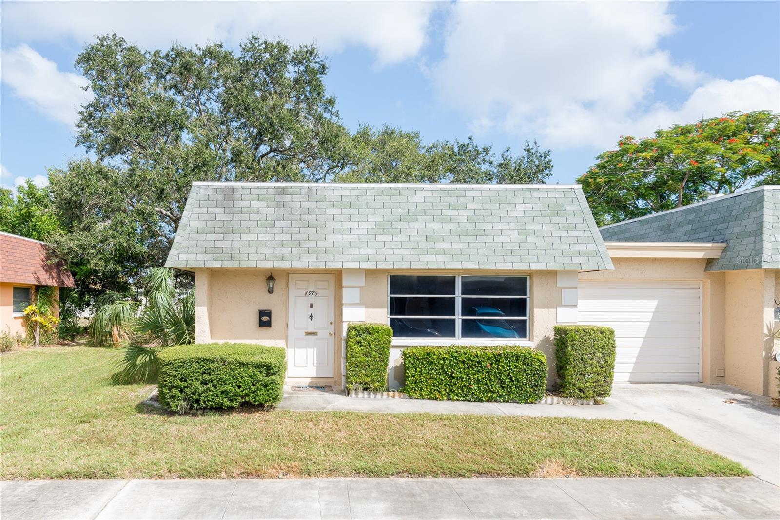 Are you looking for your retirement paradise or just fleeing the northern winters? If so, this 55+ community is the place for you! As you enter the front door you will immediately notice the new water- proof vinyl flooring and the open floor plan. The living area flows into the kitchen. The large open area adjacent to the kitchen can be used as a dining area, additional living area or office space.  As you enter the home to your right there is a half bathroom for your guests. As you continue through the living area the master bedroom is on the right. This condo is an end unit and also does not have any units behind the condo. There is an abundance of closet space with a large bedroom closet, a walk-in closet in the hallway and an entry closet as you walk in the front door. The community has a resort-like pool and large club house as well as shuffleboard courts and horseshoe pits. The Condo association fee includes Spectrum cable and internet, as well as exterior yard maintenance, water, sewage and garbage. The AC unit and water heater are only 5 years old. The Electrical Panel was replaced in December 2022. The roof is only 8 years old and the responsibility of the condo association when replacement is needed. Did I mention that you are only a 15 minute drive to beautiful Gulf beaches? There are also many restaurants and shops nearby.