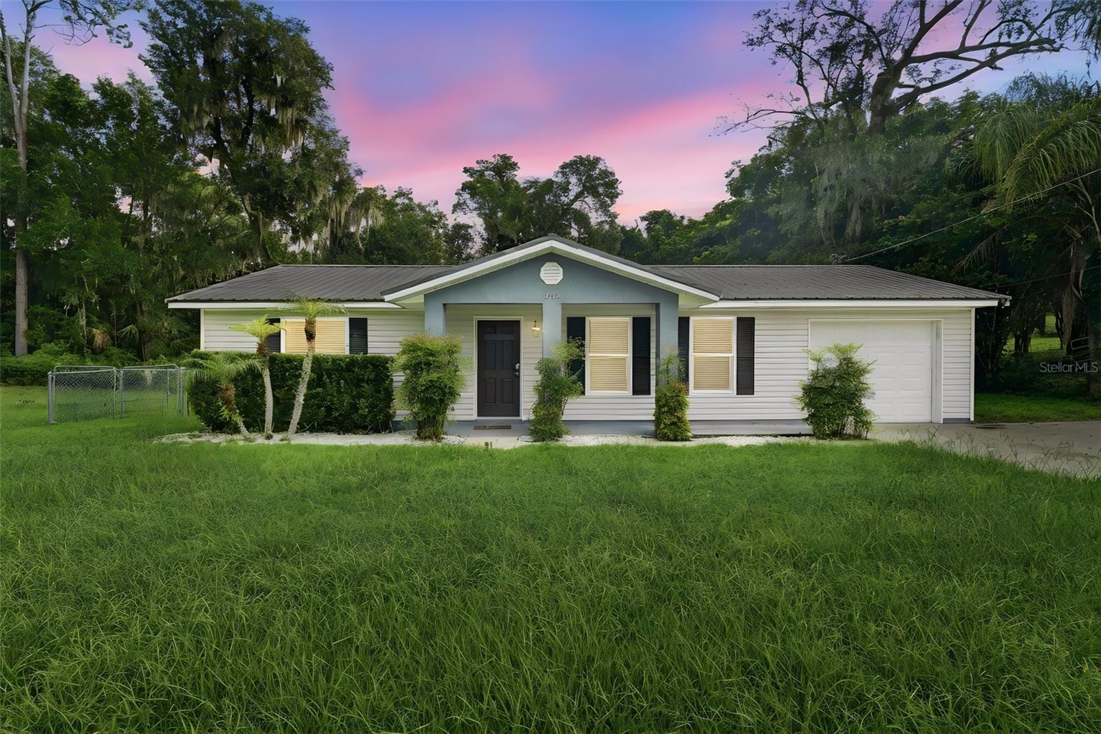 A little bungalow charm with a modern twist, that’s what you’ll find in this thoughtfully rebuilt DeLand home. Completely reconstructed from the slab up in 2017, this home offers the character of a cozy bungalow with the peace of mind that comes with newer construction. Energy efficiency was a priority during the rebuild with features including a metal roof, Low-E double pane windows, and a high-efficiency AC system. Walking through the front door, you step into the living room where the home naturally opens up toward the kitchen and dining area. The layout feels comfortable and practical, giving you a space that works just as well for anyone. The kitchen features large granite countertops, stainless steel appliances, and the kind of setup that makes cooking a breeze. Just off the dining area, a hallway leads to all three bedrooms. The primary bedroom is tucked away in the back right corner of the home, offering a quieter spot to unwind with its private en-suite bathroom, dual sinks, granite vanity, and walk-in closet. Two additional bedrooms are located down the hall along with the second full bathroom and a convenient linen closet. The Inside laundry room has additional storage space and washer and dryer are included!  From the kitchen, you can head into the one-car garage or step out to the screened-in patio overlooking the spacious fenced backyard. Whether your plans include a garden, a play area, a place for pets to roam, a workshop space, or simply a shaded spot to relax at the end of the day, this backyard gives you room to make it your own. Located in the charming town of DeLand, you’re close to Downtown DeLand, Stetson University, shopping, restaurants, Earl Brown Park, the Sanborn Activity & Events Center, and more. A home with modern updates, a comfortable layout, and that cozy bungalow feel that’s becoming harder to find, this one is worth taking a look at.