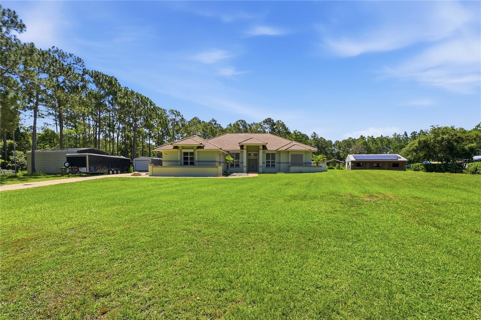 Land like this is running out. Real acreage, real privacy, and no HOA within reach of Orlando get harder to find every year. You will find all three at the end of a quiet cul-de-sac in the Bay Lake Ranch area, on 5.4 acres backing to conservation land. No HOA. No approval needed for how you live. Park the trailer where you want, keep the animals you want, and run your property the way you see fit. Plenty of listings out here call themselves equestrian. Most are a half acre and a shed. This is the real thing. A seven-stall barn, hay storage, a chicken coop, and a full corral are ready the day you arrive, wrapped in fenced pasture. You are not starting from scratch. Move in, turn the animals out, and start living the life this kind of property was built for. Inside, four bedrooms, three and a half baths, and just over 3,200 square feet give everyone room to spread out. The layout is open, the ceilings are high, and a dedicated office lets you work from home without surrendering a bedroom. The primary suite is its own retreat, with two walk-in closets, a soaking tub, and a separate shower. Pull up to the fireplace when the weather turns cooler. Out back, your screened pool and covered patio turn hosting from a chore into something you look forward to. The whole property runs on 53 solar panels, owned outright and mounted on the barn to keep the home's roof clean. You get the savings and the independence with nothing to assume. And you give up no convenience for it. Lake Nona, Medical City, and Orlando are a short drive, so the land and the quiet never cost you access to the things that pull people to this part of the state. A working horse property this close to Orlando almost never comes up. You have been looking for room to breathe. Here it is.