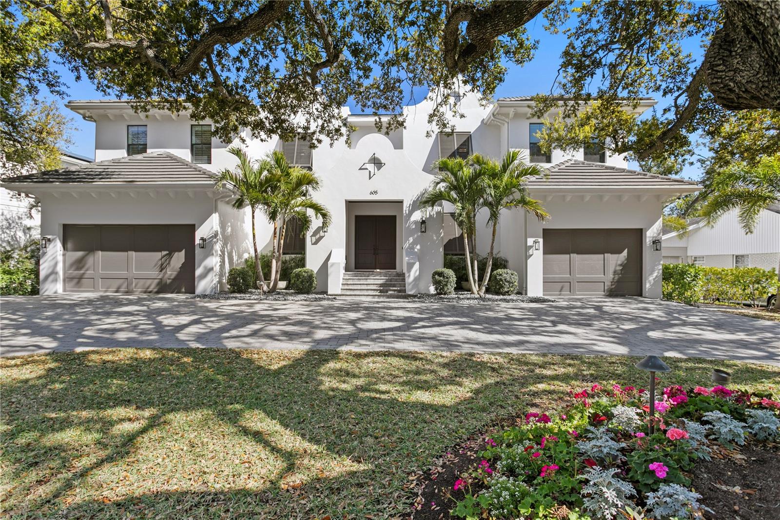 Under contract-accepting backup offers. Welcome to this beautiful Dutch West Indies–inspired home on highly sought-after Davis Island. Sited on an oversized 101' x 123' lot and built by TB Homes, this meticulously upgraded residence offers 5 bedrooms, 5.5 baths, a private office, gym, media room and expansive living spaces crafted for luxury living and entertaining.
Recent comprehensive upgrades throughout the home include full interior, garage and exterior paint; all-new interior and exterior door hardware and cabinet hardware; upgraded lighting package (sconces, chandeliers, recessed LED, under-cabinet and art lights); replaced plumbing fixtures in every bath and kitchen; new smoke/CO detectors; and matching wood floor transitions. A Savant whole-home system with Lutron controls, exterior cameras, and TVs in bedrooms, media room, playroom, outdoor porch and living room provides seamless AV and security control via app or two onsite iPads.
The gourmet kitchen was fully refaced and enhanced — new crown/trim, cabinet faces and hardware, quartz/stone tops, Calacatta herringbone backsplash, two Cove dishwashers, new apron-front farmhouse sink, pot filler and a replaced Wolf range. The adjacent breakfast hutch and custom pantry complete this chef-ready layout.
The main level hosts a formal dining room, parlor with gas fireplace, private guest suite, office, massive great room with wet bar, and direct access to the extraordinary outdoor living. The lanai features cypress ceilings, motorized screens, Travertine pavers, a custom-built outdoor kitchen with vented hood, rotisserie grill, undercounter fridge and stone tops, mounted TV/speakers, turf, landscape lighting and Mosquito Nix system. Pool area includes gas-heated spa, sunshelf and automated salt system.
Upstairs the master retreat features dual chandeliers, built-in AV, his-and-hers custom closets and a completely renovated spa-like master bath with marble, frameless glass shower, freestanding tub, custom double vanity and Toto Neorest toilet. All guest bathrooms were similarly remodeled; bedrooms and key rooms received custom closet builds, window treatments, TVs and speaker systems.
Additional upgrades: custom built-ins throughout, garage mini-split ACs, epoxy floor coatings, custom storage and bike racks, water softener, added wine/True fridge, tankless gas water heater, spray-foam insulation, impact/low-E windows, cement tile roof and a 3-car garage.
Davis Islands offers a walkable, upscale lifestyle with parks, dining, tennis, yacht basin, dog parks, Peter O’Knight Airport and proximity to Tampa General Hospital, Downtown Tampa, Water Street, Sparkman Wharf and the Riverwalk. This home is a rare, turnkey blend of craftsmanship, scale and modern technology — ready for immediate enjoyment.