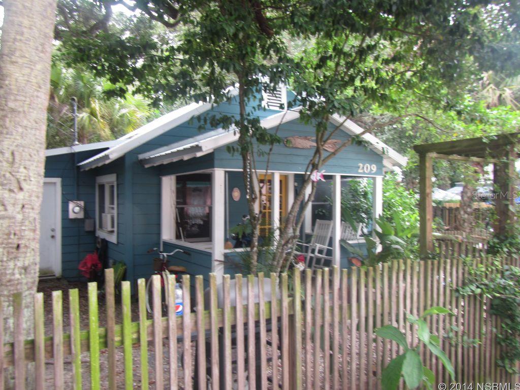 COZY BEACHSIDE COTTAGE LOCATED ON DESIRABLE ESTHER STREET!  "KEY WEST" Artsy Street just 2 blocks north of Hopping Flagler Ave, New Smyrna Beach.  Updated kitchen, wood flooring, open front porch and fenced yard. New Metal Roof 2013 isn  1 car parking spot to the west side of home with room to expand to the east side of home.  Historically Flagler Ave has fine dining, wine walks, boutique shopping, art shows, street festivals and much more ;Water: City