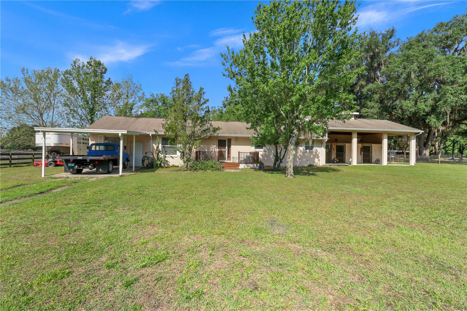 Price Improvement! Absolutely move-in ready and clean as a whittle. 
If you ever wished you could share space with your most loved 4-legged, equine friends then here is your chance. Beautiful park-like setting on this 5 acre equestrian paradise. 
All the things you would want and expect on a large scale farm, we have in a cozy and manageable 5 acre setting for you. Three stall, concrete block construction, barn attached to the house making it convenient to check on your horses without ever leaving your covered aisle way with cement floor.
Each stall has a run behind the stalls leading to the pastures. Metal rolling doors for entrance and a double door on the back of each stall. Open the top just for some cross breeze or top and bottom for access to the paddock. Fenced and cross fenced with three board creosote boards and no climb wire for three separate pastures. Separate aisle in between pastures. Gorgeous grandfather oaks for amazing shade. Wash rack with hot and cold water. Additional barn for hay/feed, and a 60 foot round pen. If you love your horses as much as we do, that was the most important part right?  Now wait till you see the house. Huge, open floor plan with natural light pouring in from every direction. The kitchen has all new stainless steel appliances and gorgeous new granite counter tops. The bathrooms were also recently topped off with new granite as well as new faucets. Giant screened porch perfect for morning coffee or watching the farm for a relaxing evening. Very easy to show but by appointment only. Your next homestead is waiting for you and your favorite farm friends are welcomed too. Chickens, pups, goats they can all come. No HOA or deed restrictions. All high and dry, no flood insurance required. Conveniently located just minutes from the great town of Bushnell but tucked away down a private lime-rock drive   They say you can have it all….and we think this is it. Call today.