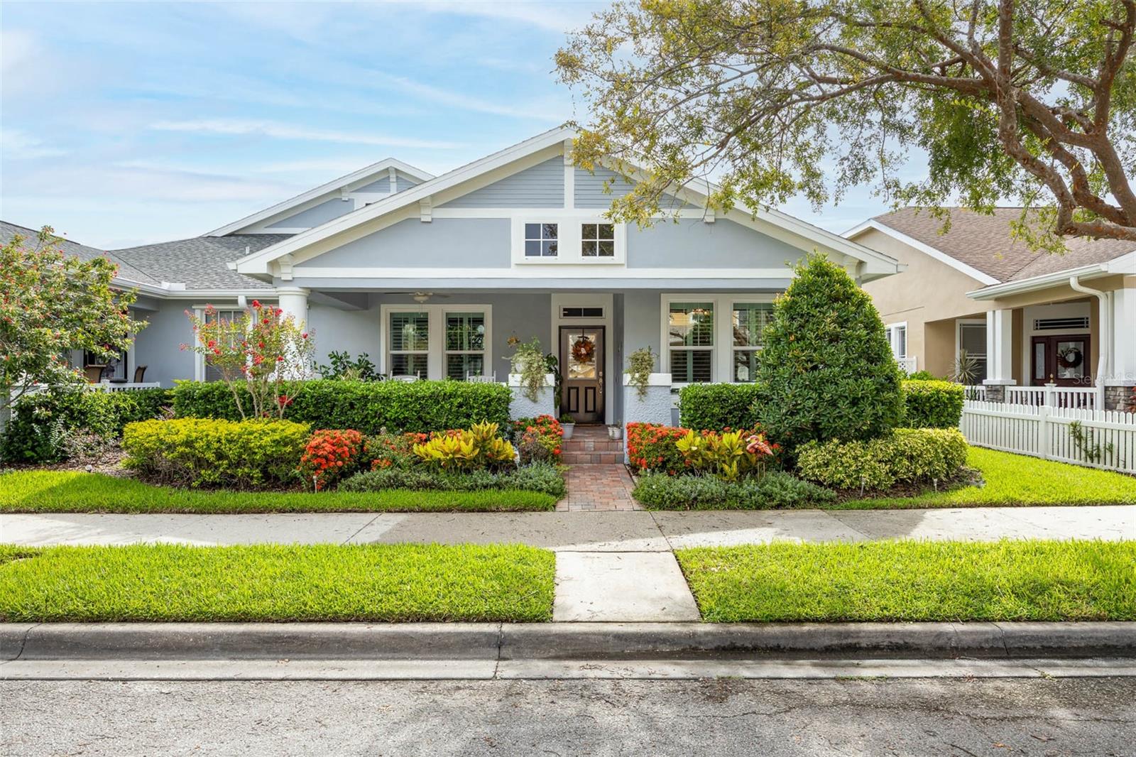 Beautifully reimagined from top to bottom, this exceptional neo-traditional bungalow seamlessly blends classic character with today’s most desirable upgrades. Featuring 2 bedrooms, 2 beautifully appointed bathrooms, a private study, and a rear-entry two-car garage, this turnkey villa welcomes you with an expansive paver front porch and designer finishes that define luxury living. Major upgrades include: impact windows and doors, custom kitchen (2021) featuring cambria quartz countertops, stainless appliances including a one year old refrigerator, new guest bathroom with high quality tile, top-of-the-line Navien® tankless gas water heater (2022), new Carrier® high-efficiency HVAC system (2024) updated electrical wiring with whole-home surge protection, water softener hookups, lanai built in 2021 with pro-glass screens and custom garage organization system, with a professionally finished polyaspartic garage. Roof was replaced in 2022 and exterior repainted in summer of 2025