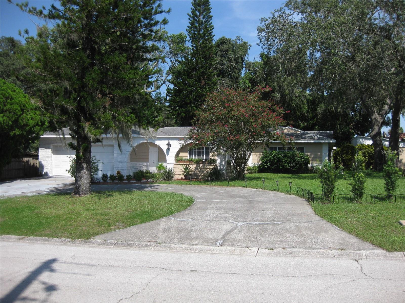 Spacious, Unique, Large sunroom, No HOA

This is a spacious 2243 sq ft home with 3 bedrooms and 2 bathrooms and a 2 car garage.  The home has a family room, living room, dining room, study/music room, a wood burning fireplace and a nice size kitchen.  The home will be sold with furniture, kitchen appliances, washer and dryer, a generator with can power the whole house if needed, lawn mower and patio furniture.  There is an additional large sunroom (not included in the home's square footage) which has its own a/c and heat.  It is currently used as a game room (ping pong, board games, foosball, exercise equipment, etc., all stay).  The roof is 9 years old, there is a new septic system (installed May 2024), additionally paint, repairs, and updates have been made.  The yard is large (.36acres).  There are two covered patios.  The back yard has a new privacy fence and a gazebo which could accommodate a hot tub.  The uniqueness of the home is that it has an adjoining 30'x148' commercial C2 piece of property with a block building currently used for storage.  The building has its own electric meter and a shallow well.  There is no HOA.  You can walk to stores, restaurants, and there is a hospital a few blocks away.  The home is not in a flood zone and had no damages or flooding during the last hurricanes.  Despite being close to a few businesses this is a quiet street with great neighbors.  It is a nice location just few blocks from downtown New Port Richey and the beautiful Sims Park.