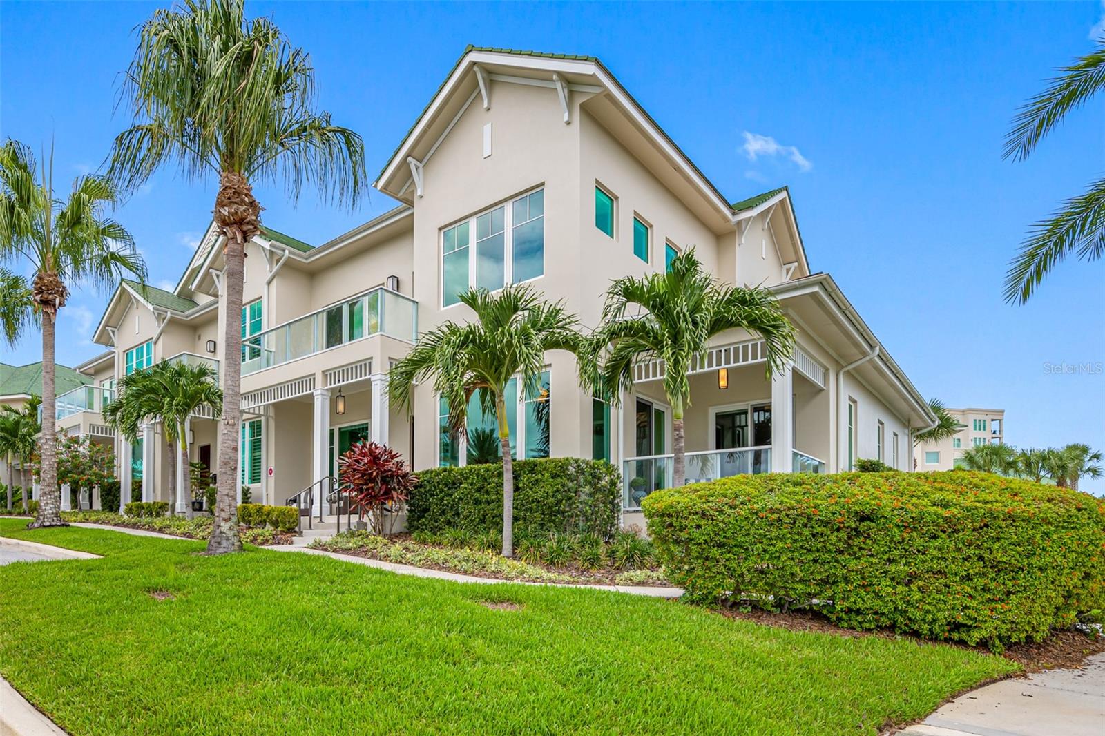 Located high on a 35’ bluff in the desired Town of Belleair and within the exclusive guard gated Belleview Place community with its popular country club and golf courses. This residence is in a NO flood zone and a NO evacuation zone and was selected to be the developer’s model townhome because of its superior location and amenities. This impressive 3,274 sq. ft. Carriage Home has 3 bedrooms, 3 full baths, a powder room, a Bonus/Flex Room, an elegant elevator, a 2 Car Garage and a corner location which provides expansive views of the community’s picturesque landscape.  As a very special feature, this residence was substantially improved beyond the builder’s standards with the addition of insulation and seals under the oversight of licensed contractors, specialists and lab technicians to nullify any potential impact of the moist tropical environment.  These improvements add to the energy efficiency, superior air quality and comfort. When combined with the insulated impact windows, this residence experienced NO adverse effects from the recently challenging weather conditions. Step through the custom front door and be welcomed by soaring ceilings and a series of large picture windows that fill the home with natural light. Hardwood floors, crown molding and electric blinds enhance the elegance and functionality of the space. The living room features a gas fireplace with a stunning stone design and custom built-ins. The kitchen is a chef’s delight with top of the line stainless JennAir appliances including a gas cooktop, an abundance of white wood cabinetry and a large center island with a waterfall stone countertop that accommodates breakfast bar seating. A formal dining area, currently serving as a conversation area, adds to the dynamic layout. The first-level Primary Suite has direct access to the covered patio with its clear glass railings plus high tray ceilings, large windows, and his and hers closets. The ensuite bathroom has a double sink vanity, a separate commode room, walk-in shower with built-in seat, and a separate makeup vanity. Access to the second level is by private elevator or the elegant staircase. This level consists of two ensuite guest bedrooms and a flex room (office, gym, media room) with built-ins and stunning views. The larger guest bedroom can be an alternative Primary Suite with its private balcony, custom walk-in closet, ensuite bathroom with double sink vanity, separate commode room and walk-in shower. The third bedroom is complete with a custom walk-in closet and an ensuite bathroom. The spacious laundry room, located on the first level, features custom cabinetry, a laundry sink, a built-in wine fridge and a full-size washer and gas dryer. The attached oversized 2-car garage (nearly 500 sq. ft.) includes custom cabinetry and a Tesla Electric Charger. The adjacent patio is perfect for outdoor grilling. All public utilities are underground for ambience and safety. The entrance is guarded 24/7. Amenities include a fitness center, magnificent heated pool & spa, pool-side restrooms, cabanas, sundeck and garden pergolas all of which are located at the iconic Belleview Inn. Neighboring private Belleair Country Club offers world-class golf (two 18-hole courses), tennis, pickleball, croquet, pool, dining and so much more. Private marina with boat slips for rent or purchase are subject to availability. Close to the Gulf Beaches and the Pinellas Trail.  Here is the video of this beautiful home
