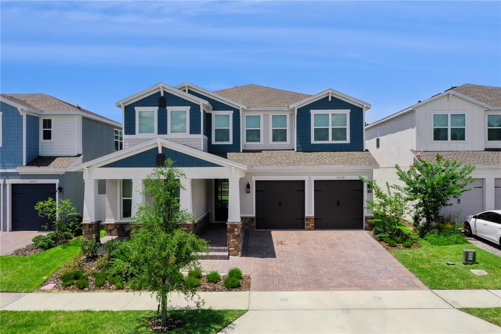 Built in 2025 and loaded with premium upgrades, this stunning 5-bedroom, 4.5-bathroom home offers 3,664 square feet of thoughtfully designed living space in one of Winter Garden's most sought-after locations.

The heart of the home is the impressive chef's kitchen, featuring stacked appliances, an induction cooktop, ceiling-height cabinetry, abundant storage, and designer finishes that make both everyday living and entertaining a pleasure. The open-concept layout flows seamlessly into the spacious living area, where a 12-foot glass sliding door brings in natural light and opens to a covered paver patio and backyard.

The primary suite feels like a private retreat, complete with a spa-inspired bathroom featuring a freestanding soaking tub, oversized shower, and elegant finishes throughout. Two of the home's five bedrooms offer private en-suite bathrooms, including a first-floor guest suite that provides the perfect setup for visitors, multigenerational living, or long-term guests.

Designed with flexibility in mind, the floor plan includes a massive first-floor home office, a separate dining room that can easily serve as a playroom, formal dining space, or additional workspace, plus a spacious second-floor loft. Additional highlights include a three-car tandem garage with a 50-amp electric vehicle outlet, a laundry room with utility sink, ceramic tile and laminate flooring throughout most of the home, and carpet in only three secondary bedrooms. All appliances convey with the sale.

Location is where this home truly shines. Situated less than four miles from Walt Disney World property and approximately four miles from Flamingo Crossings Town Center, you'll enjoy convenient access to shopping, dining, entertainment, and everyday essentials. The brand-new Ovation Elementary School is also scheduled to open nearby this August, adding even more appeal to this exceptional location.

If you've been searching for a move-in-ready luxury home near Disney with high-end finishes, flexible living spaces, and an unbeatable Winter Garden location, this home delivers.
