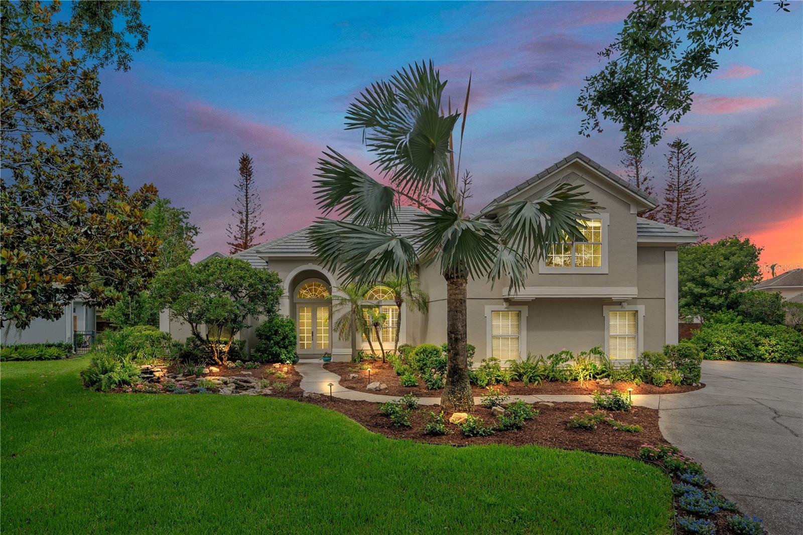Welcome to 10713 Boca Pointe Dr, an exquisitely renovated luxury home in the heart of Dr. Phillips w/3,612 sf of beautifully curated living space. Thoughtfully redesigned from top to bottom w/extensive high-end improvements, this exceptional gem combines timeless elegance, modern technology, & resort-style outdoor living. Featuring a new roof, resurfaced pool and spa, hurricane-rated windows & doors plus expansive collapsible sliding glass doors that seamlessly blend indoor & outdoor living, this is truly a move-in-ready luxury retreat. Virtually every aspect of the property has been upgraded, inc. HVAC systems, hybrid H2O heater, electrical improvements, custom millwork, designer lighting, premium finishes, & state-of-the-art technology. At the center of the home is a spectacular chef's kitchen designed for entertaining and everyday living. It features dual islands, custom walnut cabinetry, quartz countertops, Sub-Zero refrigerator, Wolf appliances inc. a six-burner gas range, convection oven & steam oven, Bosch integrated dishwasher, a spacious walk-in pantry w/custom cabinetry & a coffee bar, & designer lighting. The kitchen seamlessly blends luxury, functionality, & thoughtful design. The primary suite serves as a private retreat with dual walk-in closets w/a bathroom featuring Italian marble walls, Italian porcelain flooring, a curb-less glass shower, Jacuzzi soaking tub w/integrated lighting, quartz counters, & premium Hansgrohe fixtures. The living room creates an unforgettable first impression w/a stone feature wall, designer electric fireplace, custom built-ins, newly added windows, motorized shades, & abundant natural light. Expansive collapsible sliding glass doors create a seamless connection to the outdoor living spaces. Every bathroom has been renovated w/custom vanities, imported tile, premium fixtures, & glass-enclosed showers. Technology & comfort have been thoughtfully integrated throughout the home w/whole-home Klipsch audio serving multiple interior rooms & outdoor spaces, ethernet connectivity, whole-house surge protection, four-zone climate control, & a dedicated ductless cooling system in the primary suite. A thoughtfully expanded laundry & mudroom adds both convenience & functionality w/extensive custom cabinetry, built-in storage solutions, quartz countertops, utility sink, & an additional built-in Sub-Zero freezer, creating an exceptional space for organization & everyday living. Step outside to your private backyard retreat. The resurfaced pool & spa are complemented by a fully equipped summer kitchen featuring a built-in DCS grill, side burner, refrigerator, sink, custom cabinetry, granite counters, vent hood, integrated audio, & covered entertaining space. The lanai has new screening, doors, & exterior finishes, creating the perfect setting for year-round Florida living. The grounds are equally impressive, featuring extensive landscaping, a natural stream-inspired front water feature, raised garden beds, irrigated planters, & a water-efficient drip irrigation system. Additional highlights include an optional Vital Health infrared sauna, enhanced attic insulation, designer lighting, & countless upgrades that reflect the exceptional craftsmanship invested throughout the home. Located in one of Dr. Phillips' most desirable communities, this is a rare opportunity to own a truly turnkey luxury home where exceptional craftsmanship, modern convenience, and resort-inspired living come together beautifully.