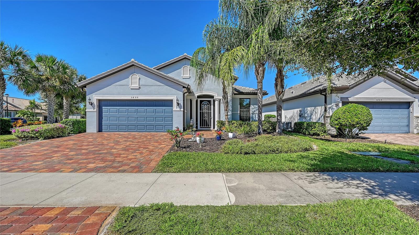 Price Improvement - Seller's are accepting any reasonable offers! Discover comfort and elegance in this charming Martin Ray 3-bedroom 2 Bath plus den. Impeccably maintained home. The inviting atmosphere is ideal for both relaxation and entertainment. Spacious and sunlit interior. The chef's kitchen features a 5-burner gas range, white cabinetry and decorative tile back splash. Huge island with ample seating. Stainless appliances, walk in pantry, uniquely designed custom built in bar area with wine cooler. Living area with cozy ambiance. Separate dining area. The primary bedroom serves as a peaceful retreat w ensuite bathroom. Large walk-in shower, double sinks and granite counters. Two additional bedrooms provide options for family and guests. Work from home in spacious den. Paver brick lanai with ambient lighting, sparkling pool and serene lake views. Additional features include custom electric screen enclosure, all new hurricane shutters, epoxy coated 2-car garage with built in cabinetry, new paver brick driveway. Come enjoy this premier lifestyle. The community amenities include a great clubhouse with activities director, tennis, pickle ball, resort pool, fitness, dog park, playground, and much more. A prime location here in Palmer Ranch, close to shopping, fine dining, world famous beaches, the Legacy trail, and minutes to downtown. 24-hour gate with secure access.