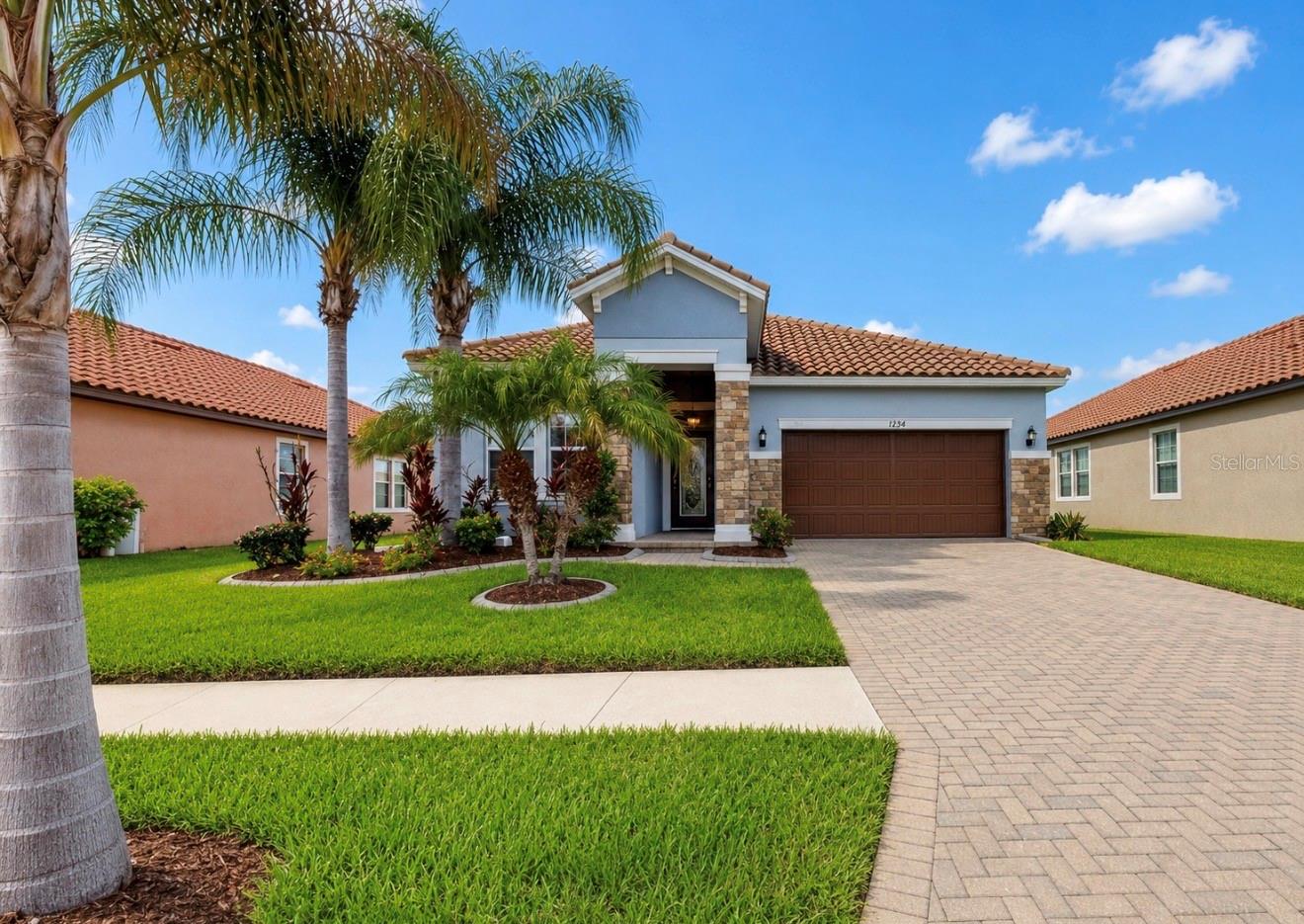 Virtually Staged. Welcome home to this beautiful 3 bedroom, 2 bath home with an OFFICE / FLEX ROOM located in the GATED, EXCLUSIVE community of Waterleaf!  Situated on a PREMIUM lot with WATER VIEWS, you will be WOWED by the incredible curb appeal, including vibrant palm trees, perfectly manicured lawn, PAVER driveway, decorative CURBING around landscape beds,  and a GRAND ENTRYWAY with stone columns and a welcoming GLASS INSERT front door.  Offering nearly 2000 square feet of living space, the interior offers plenty of room for entertaining and everyday living.  The stunning kitchen includes GRANITE countertops, stainless steel appliances, a trendy tile backsplash, pendant lighting, pantry, and ample workspace for cooking. Privately tucked away at the rear of the home, the SPACIOUS PRIMARY SUITE enjoys serene pond views, a HUGE WALK-IN CLOSET and an ensuite bath with dual sinks, a garden soaking tub, and a separate walk-in shower. Two additional generously sized bedrooms share a full bathroom, providing comfort and privacy for family members or guests.  Step outside to relax on the screened lanai overlooking the expansive FENCED BACKYARD, offering plenty of space for outdoor entertaining, pets, and play. With picturesque water views and resort-style amenities, this home is one you won't want to miss!