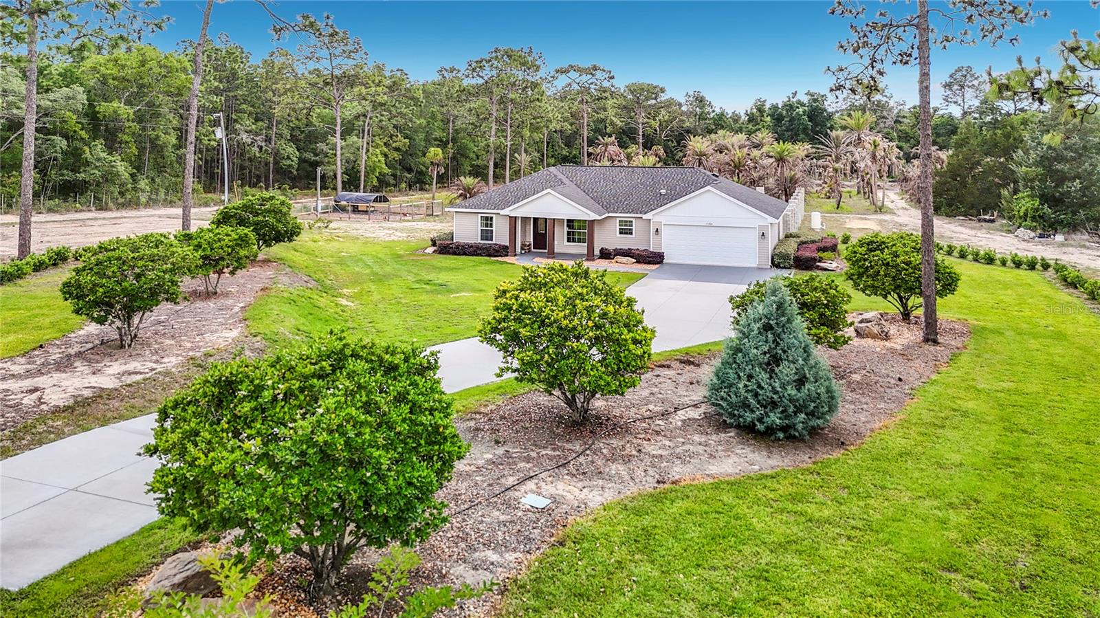 Welcome to your own private slice of Florida paradise! Nestled on 5 beautifully maintained acres, this stunning 2023-built home offers the perfect combination of modern living, country charm, and endless possibilities.  Inside, you'll find 3 bedrooms, 2 bathrooms, and a bright, open layout designed for both comfort and functionality. The kitchen serves as the heart of the home with quartz countertops, stainless steel appliances, abundant cabinet space, and an effortless flow into the dining and living areas. Wood-look tile flooring throughout provides a stylish, low-maintenance finish that complements the home's contemporary design.  Outside is where this property truly shines. Zoned agricultural and fully irrigated, the land is ideal for homesteading, gardening, livestock, or simply enjoying the privacy and beauty of wide-open space. Approximately 3 acres are serviced by an upgraded irrigation system powered by a 2-horsepower well pump and 2-inch water line, with over $15,000 invested in the system within the last three years.  The grounds have been thoughtfully landscaped with mature trees, established plantings, and lush greenery throughout, creating a peaceful setting that feels like your own private retreat. The property is fenced on three sides, and the existing chicken coop may remain for the new owners. Palm trees located toward the rear of the property are part of the family's nursery inventory and will be removed prior to closing.  For buyers seeking a turnkey opportunity, the home is available fully furnished, including furniture, televisions, and décor. Concept renderings for a future backyard oasis are also available, offering inspiration for the next chapter of this incredible property.  Conveniently located near the Suncoast Parkway, shopping, restaurants, medical facilities, and the crystal-clear waters of Weeki Wachee Springs, you'll enjoy the tranquility of country living without sacrificing convenience. With schools located less than a mile away, this property offers a rare opportunity to enjoy acreage, privacy, and modern amenities all in one exceptional package.
Buyer and buyer's agent to verify all measurements and information deemed important. Some photos may contain virtual staging enhancements.